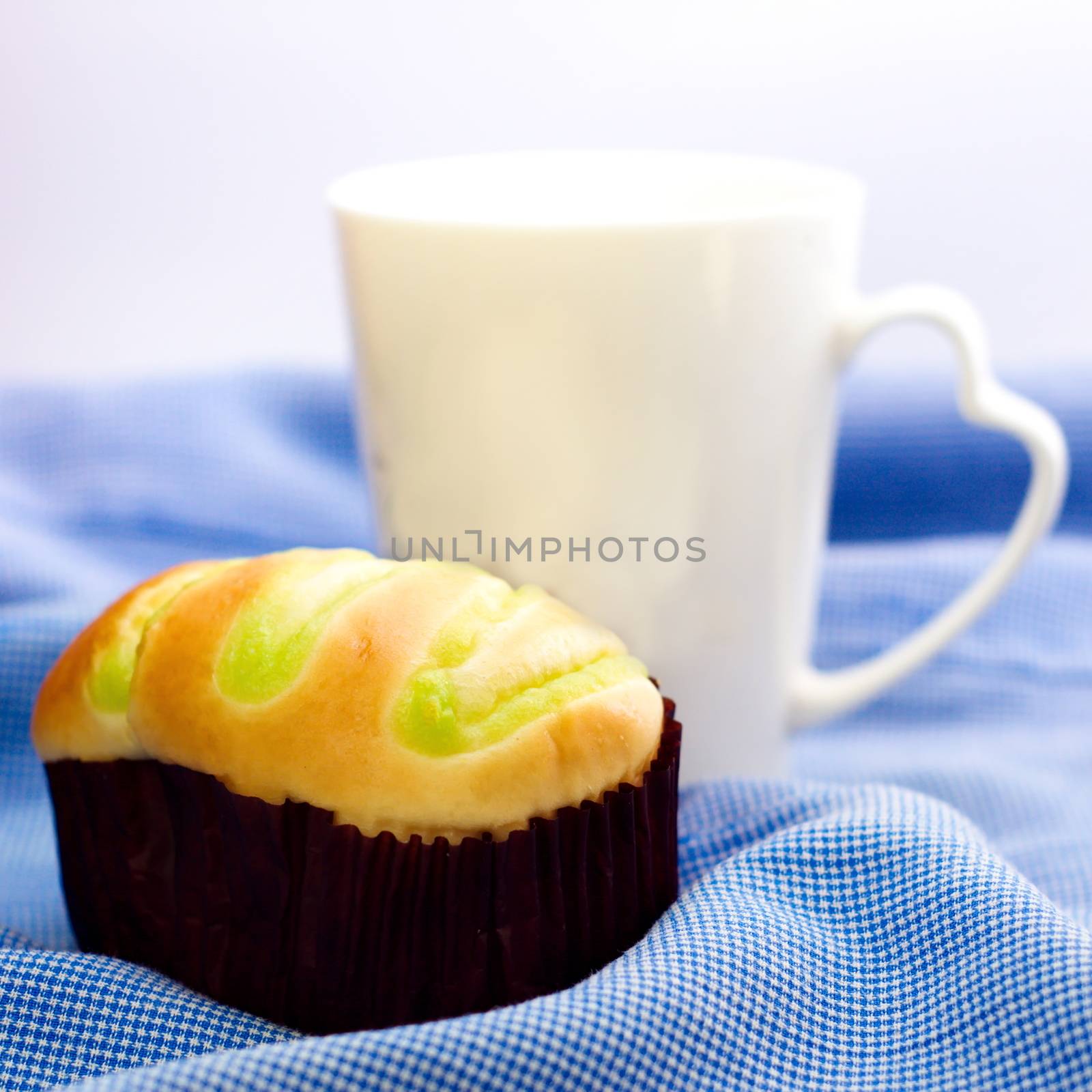 Bun and white coffee mug with word love on side