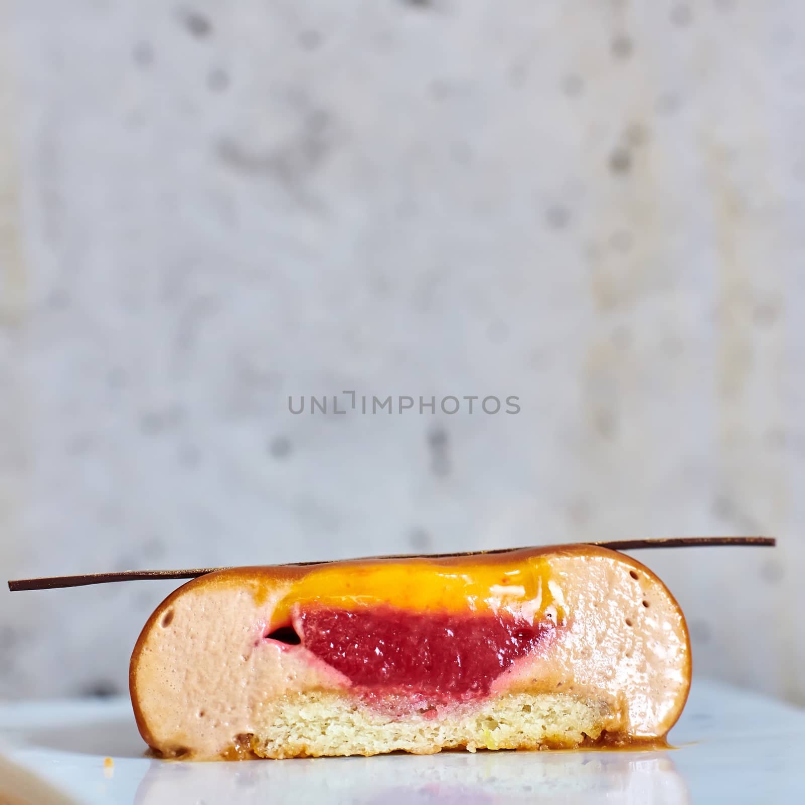 Two pink raspberry mousse desserts on a plate