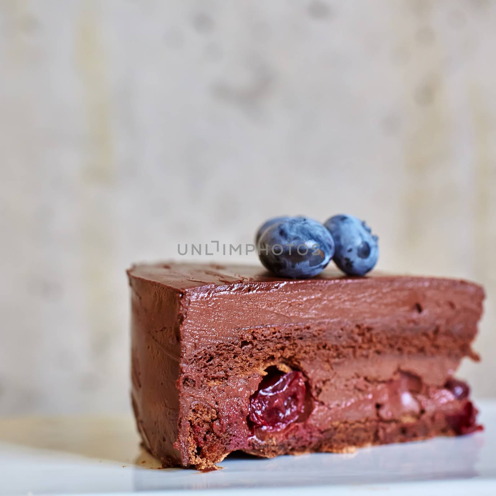 Piece of chocolate cake on concrete background