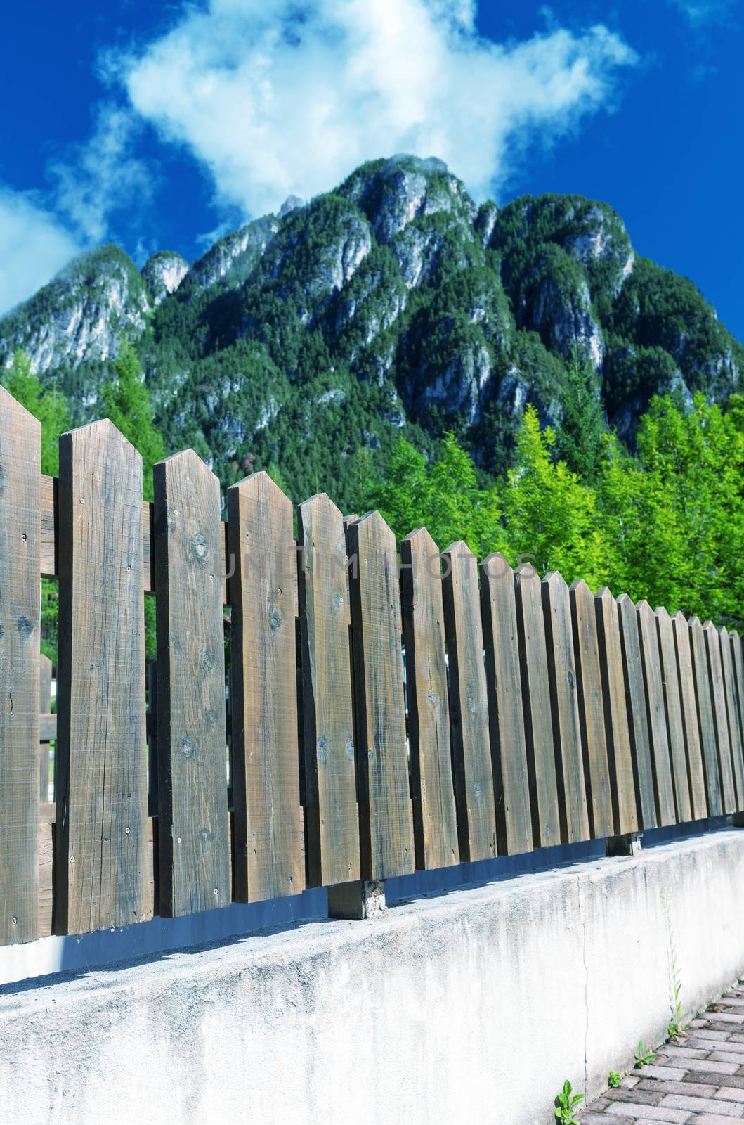 Fence underneath a beautiful mountain.