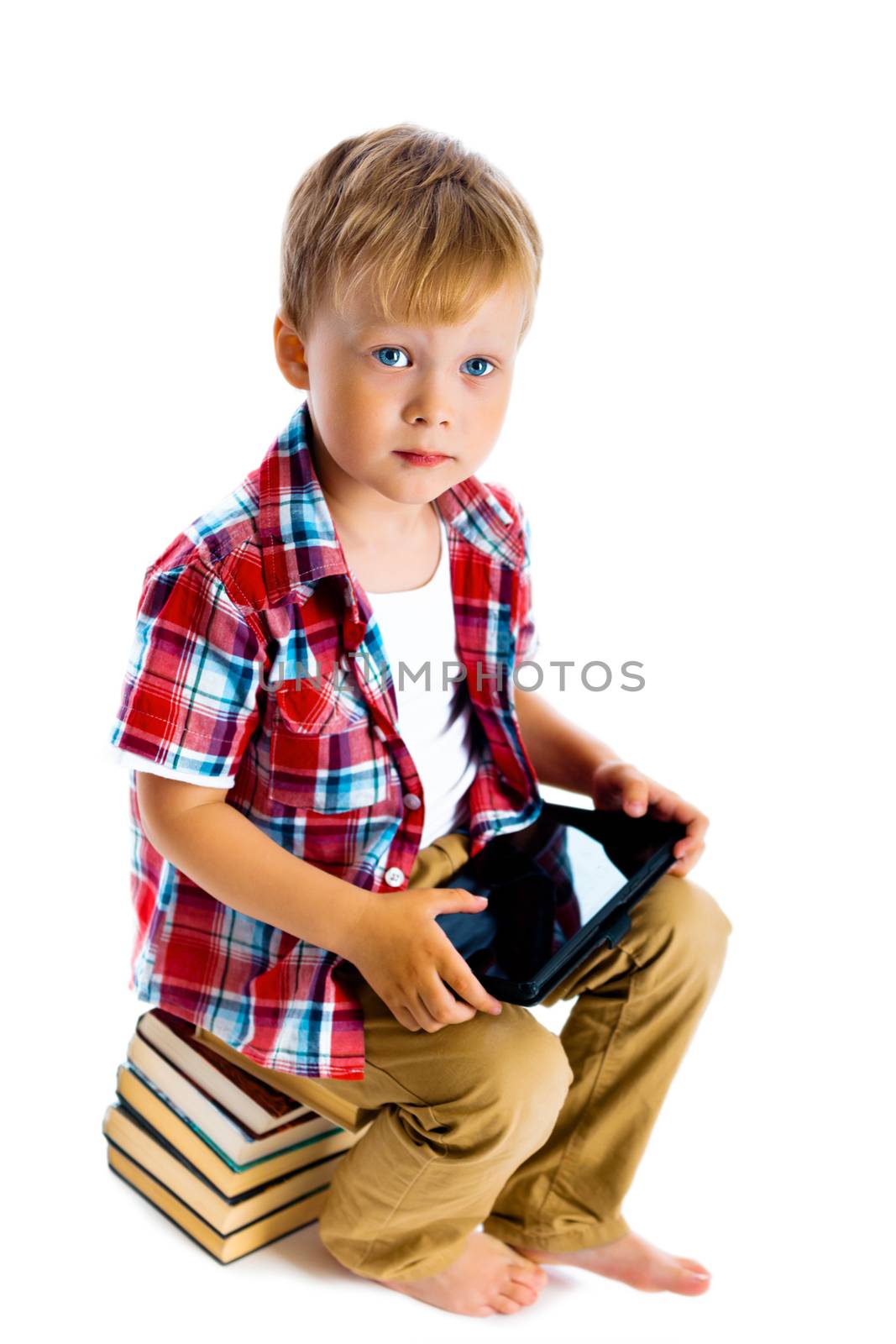 boy with a Tablet PC sitting on the books by pzRomashka