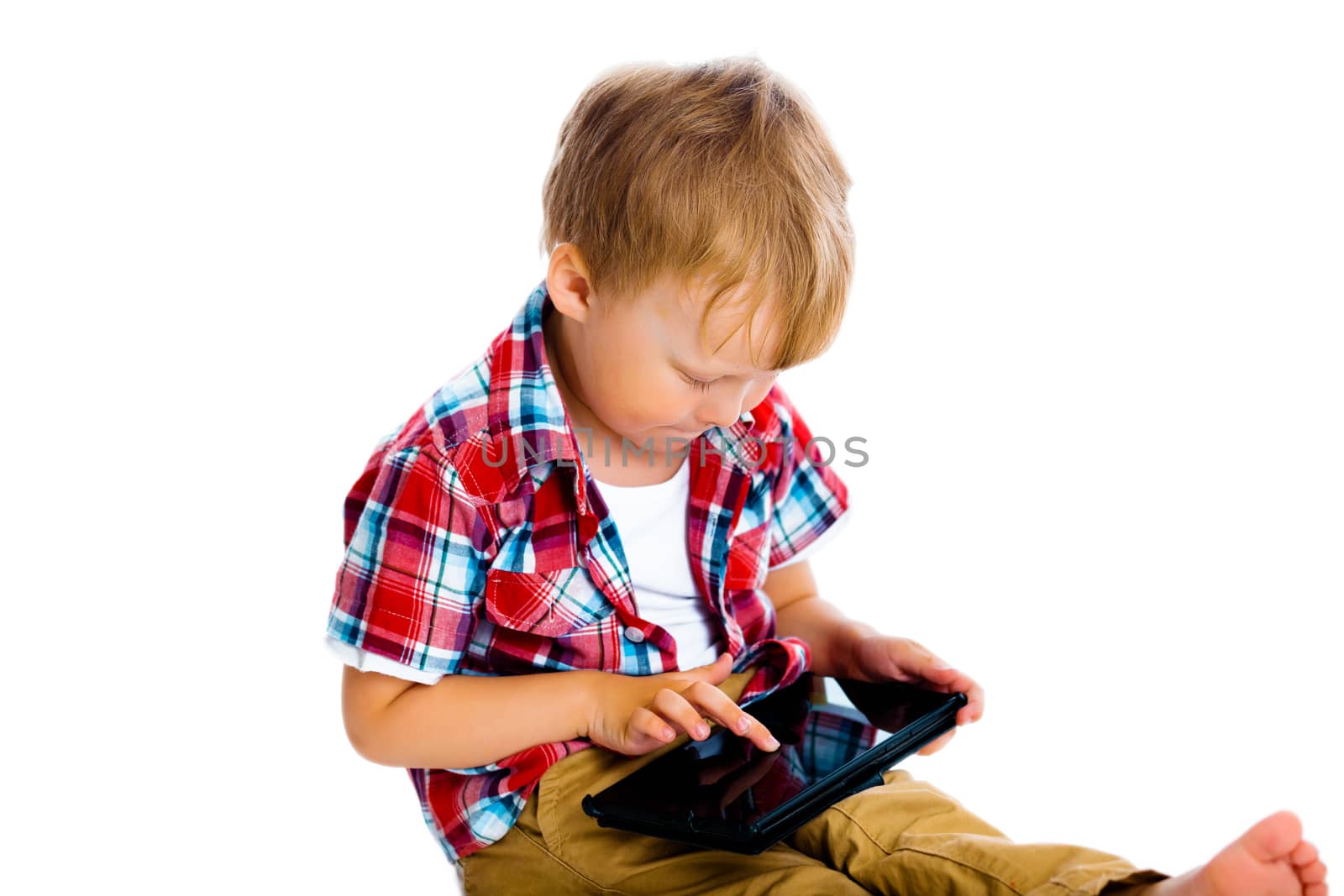 Little boy with a Tablet PC sitting on the floor