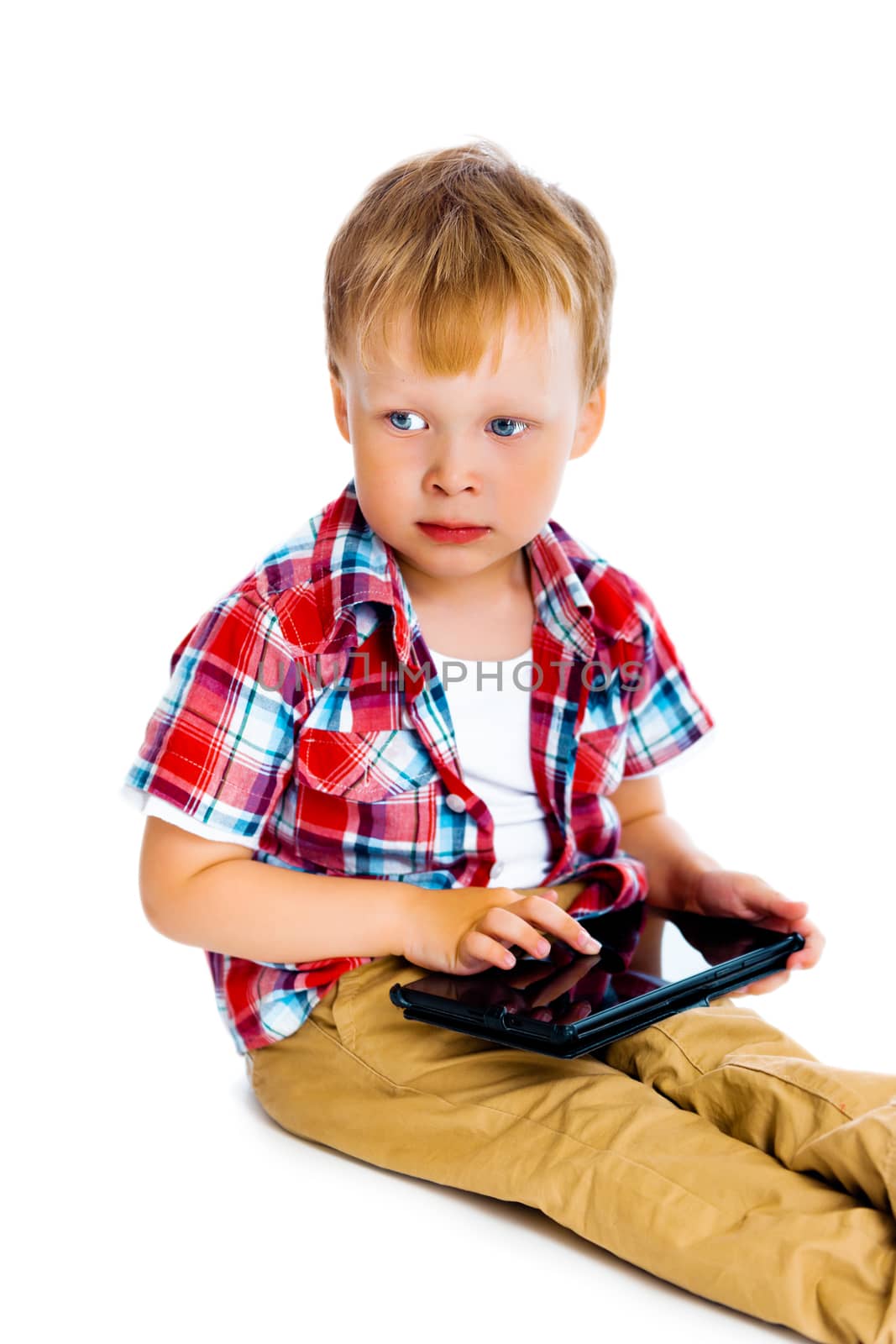 Little boy with a Tablet PC sitting on the floor