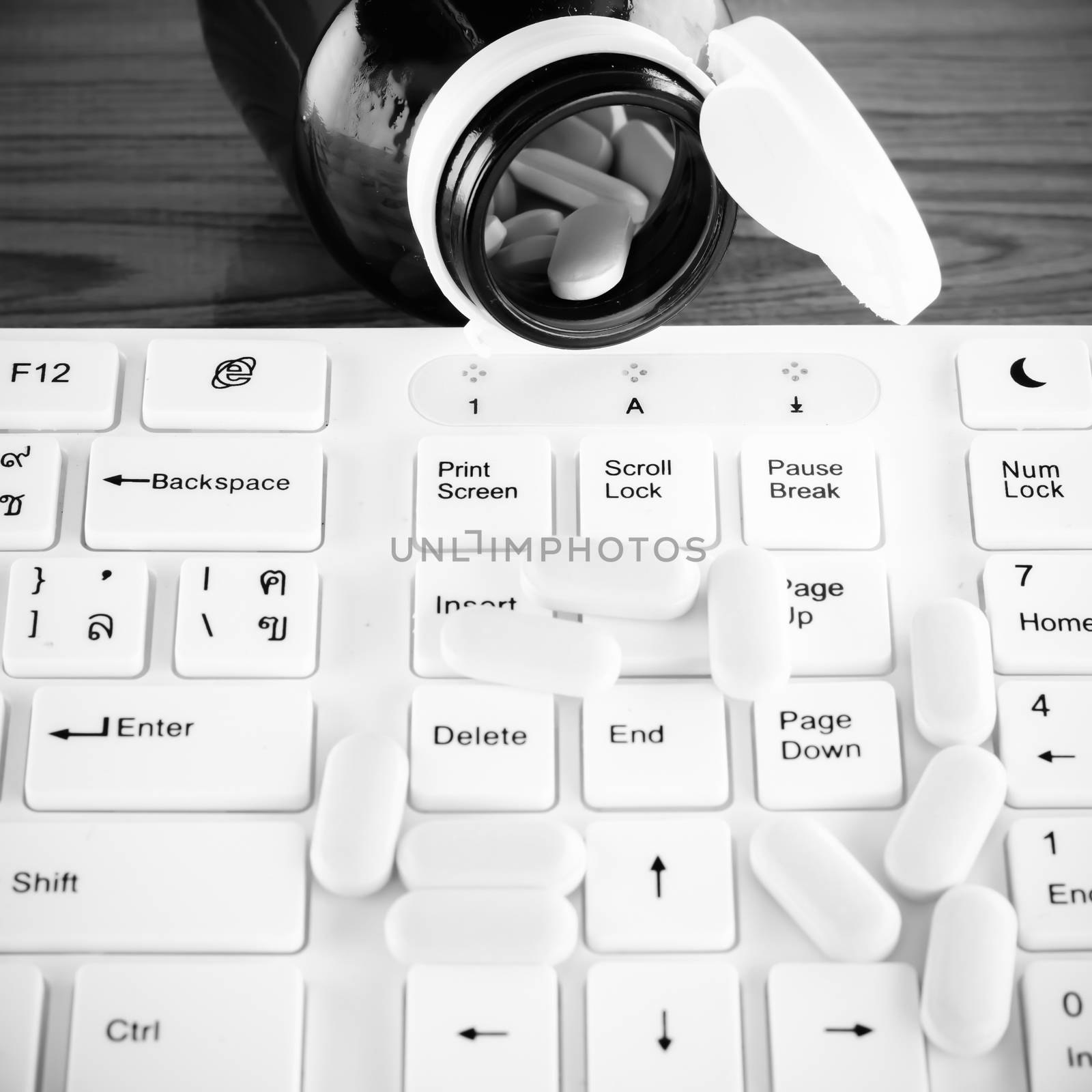 pills on keyboard computer black and white color tone style by ammza12