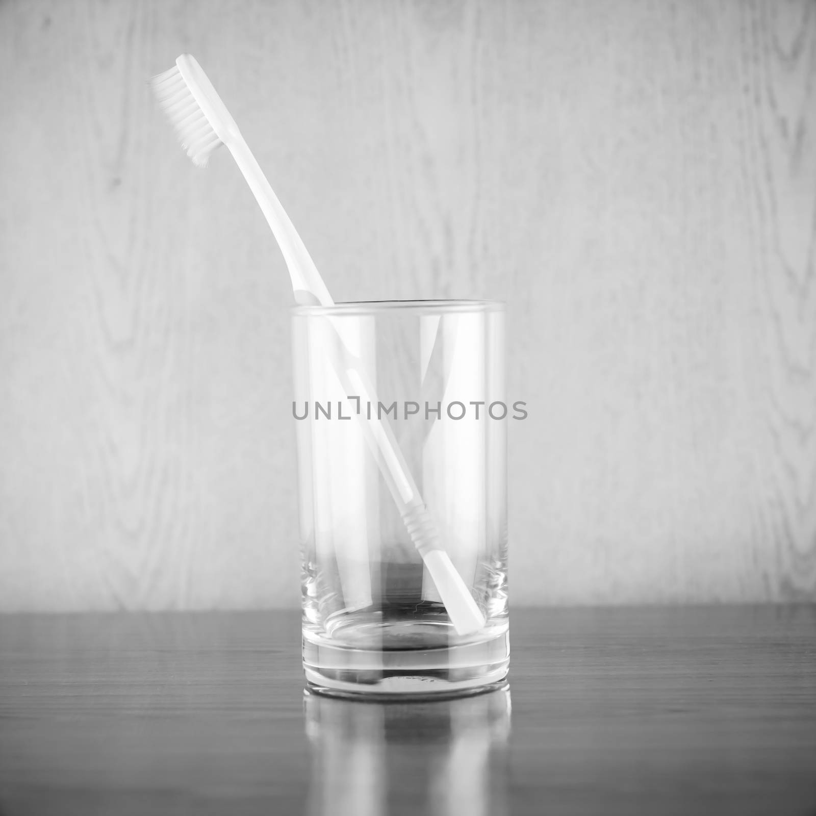 toothbrush in glass black and white color tone style by ammza12