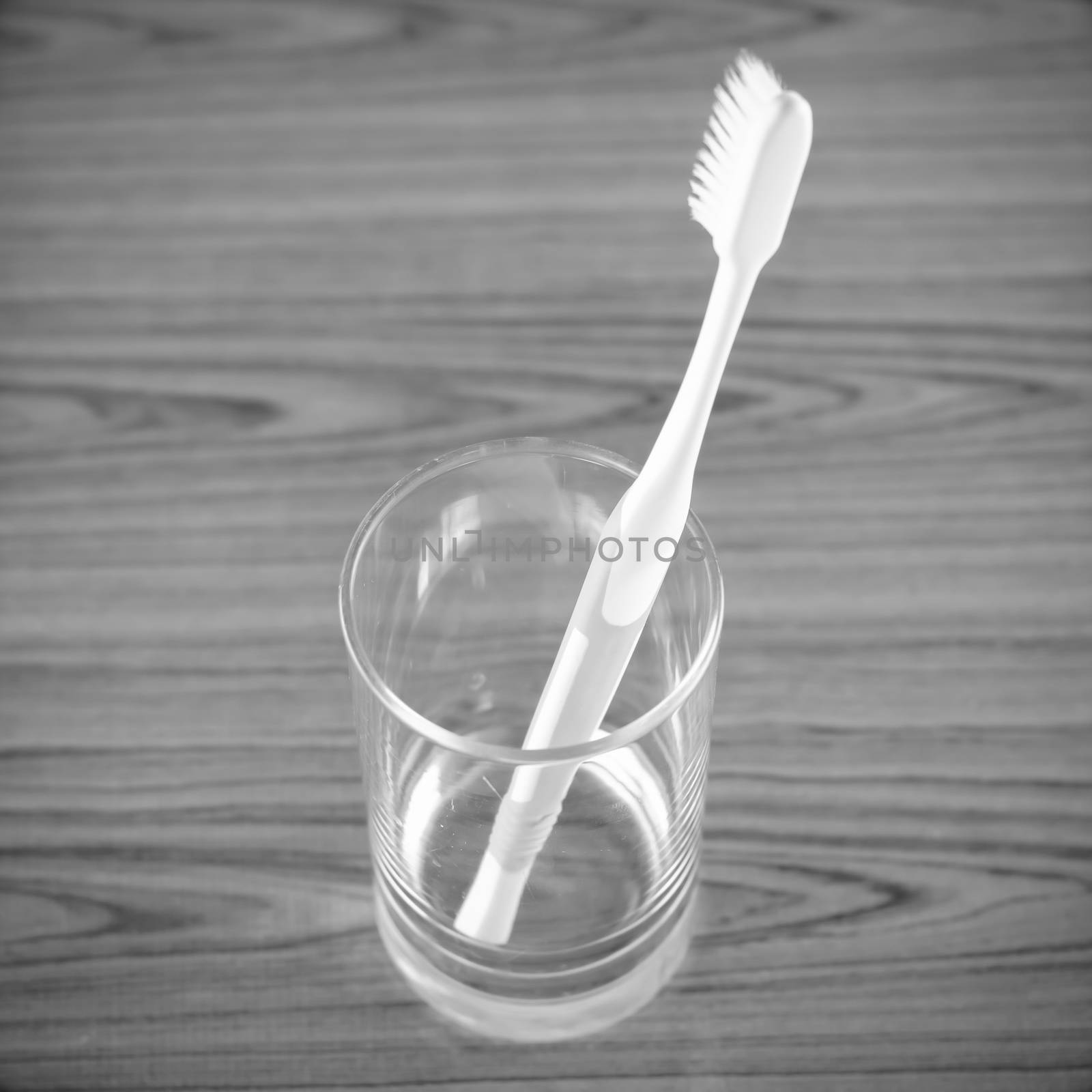 toothbrush in glass black and white color tone style by ammza12