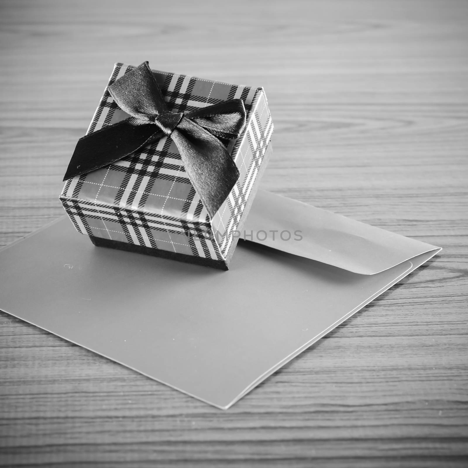 gift box and envelope on wood background black and white color tone style