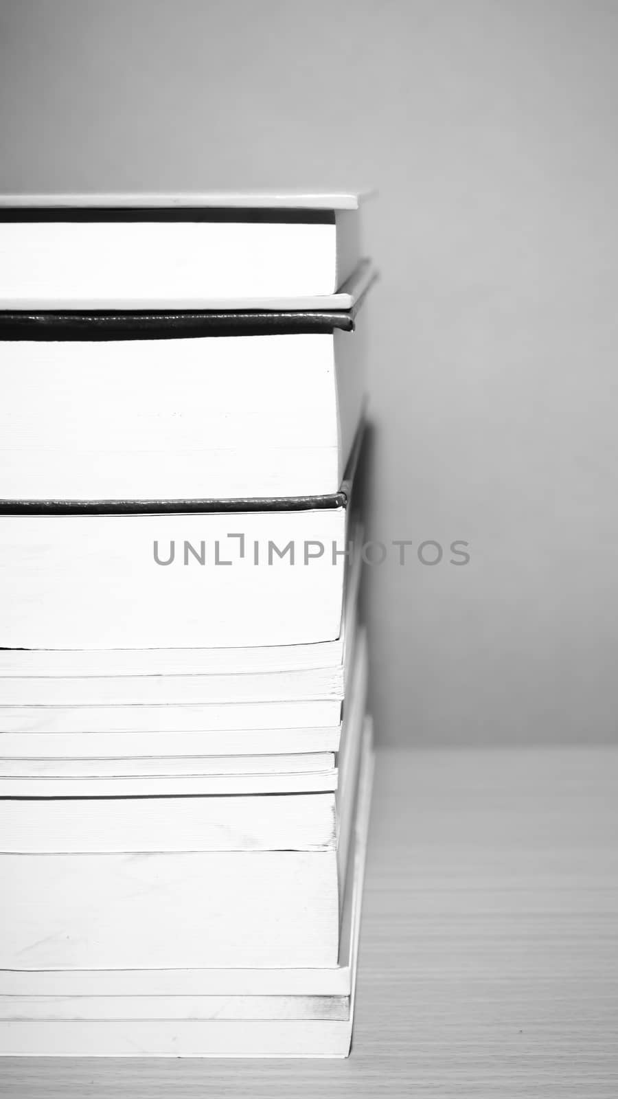 stack of book on wood table background black and white color tone style