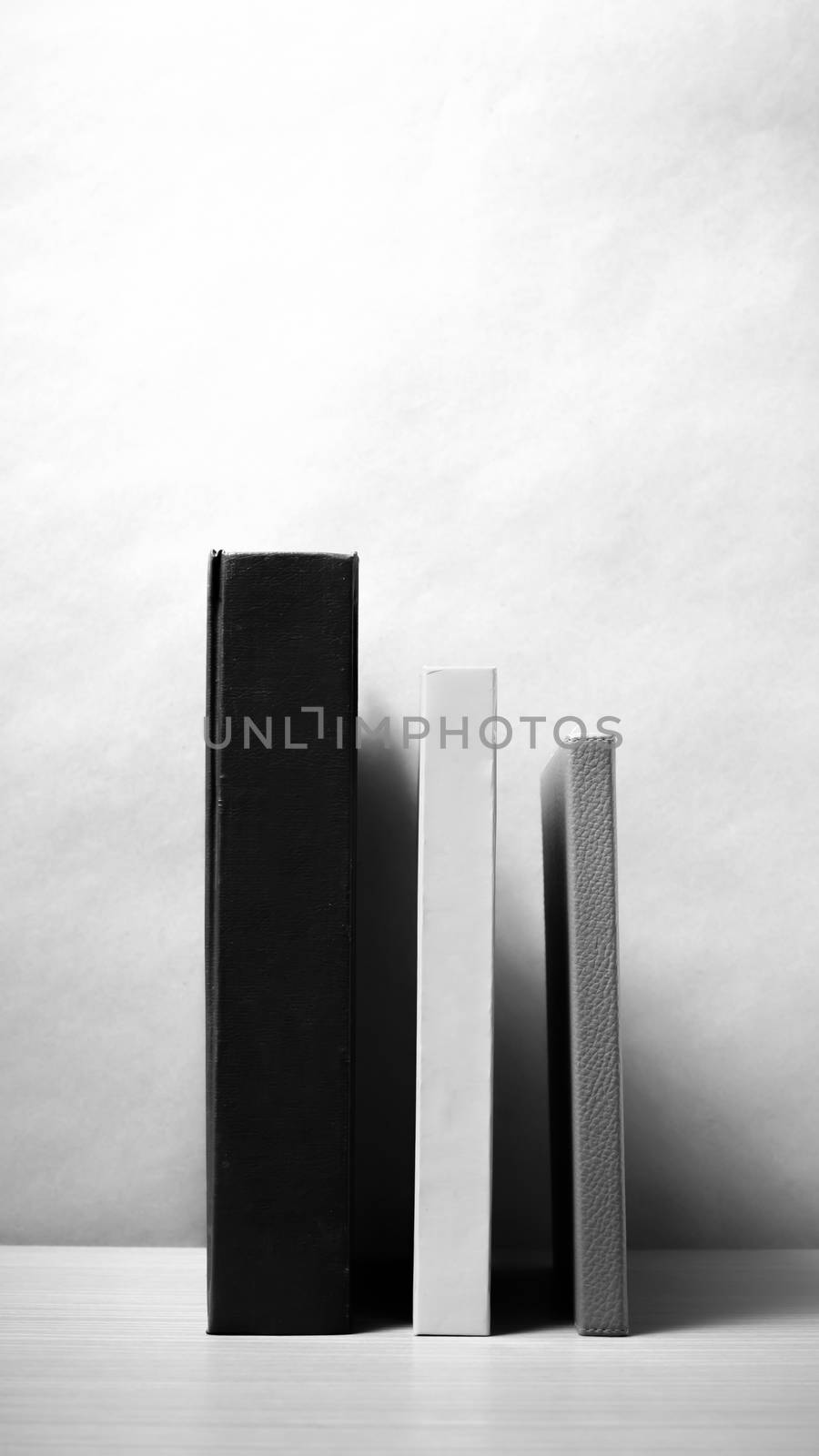 stand up of book on wood table background black and white color tone style