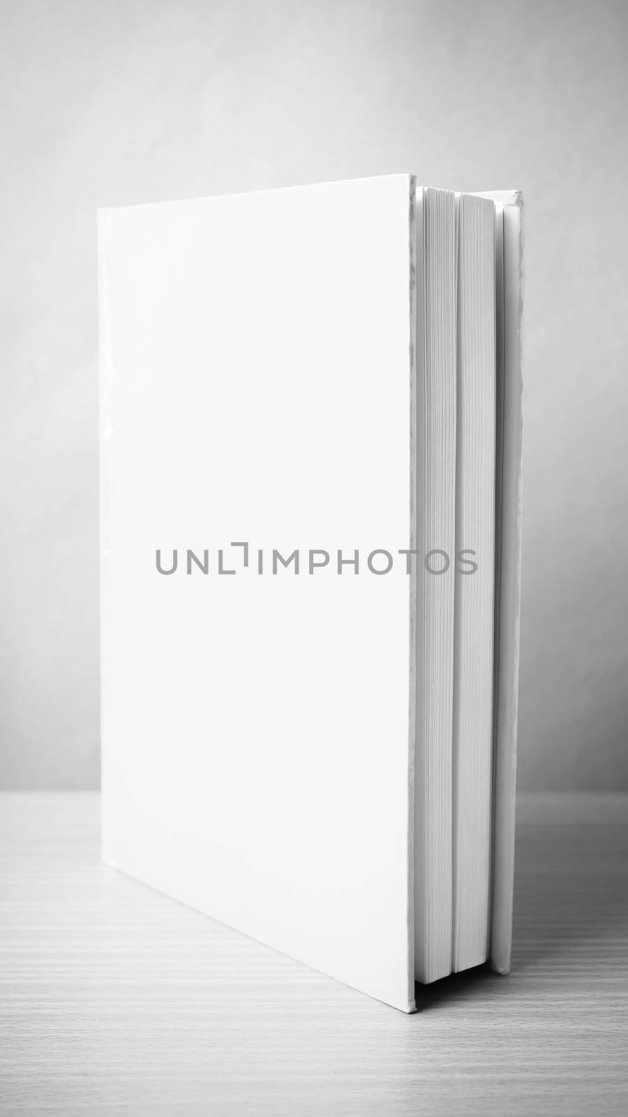 book on wood table background black and white color tone style