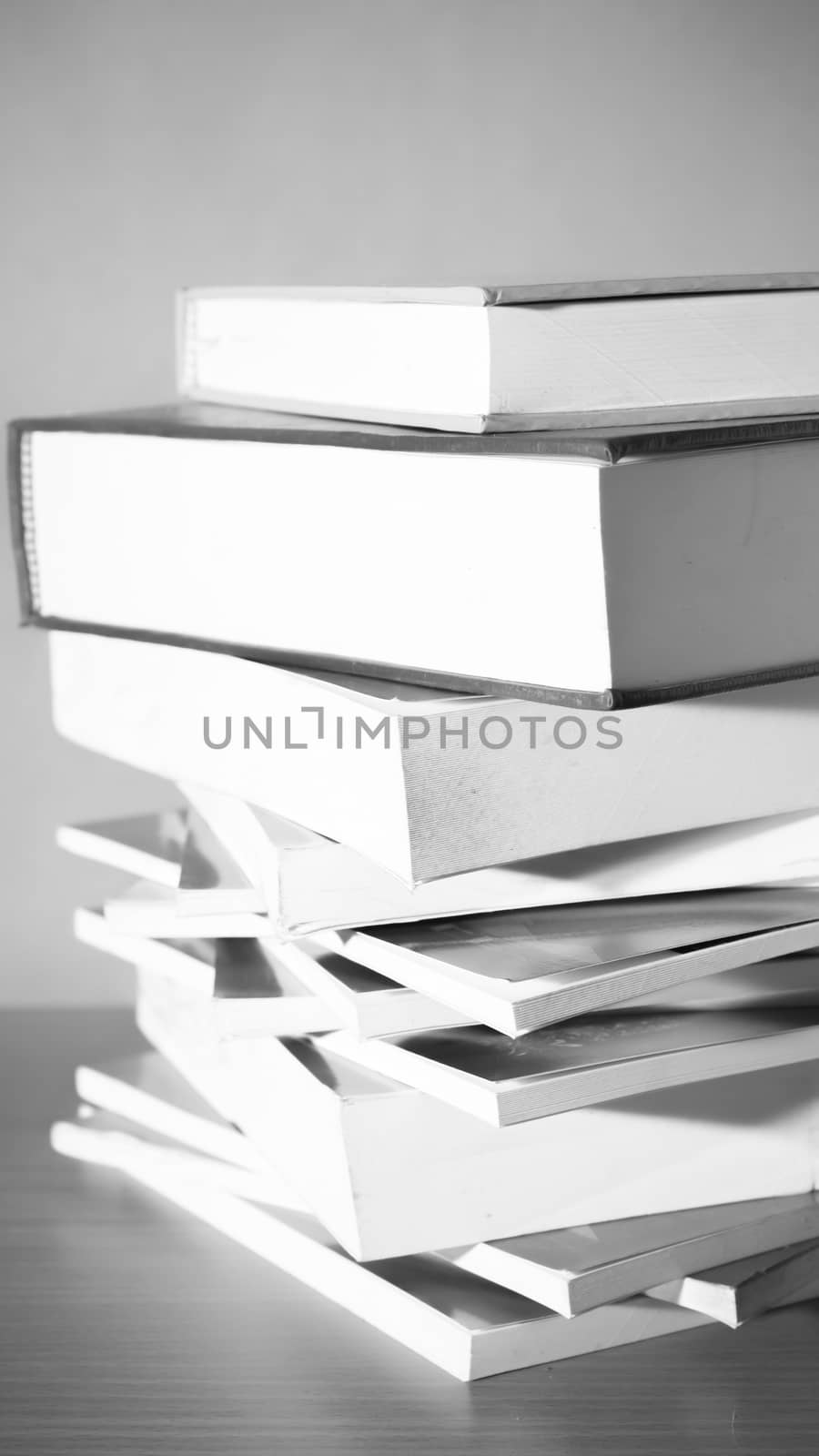 stack of book on wood table background black and white color tone style