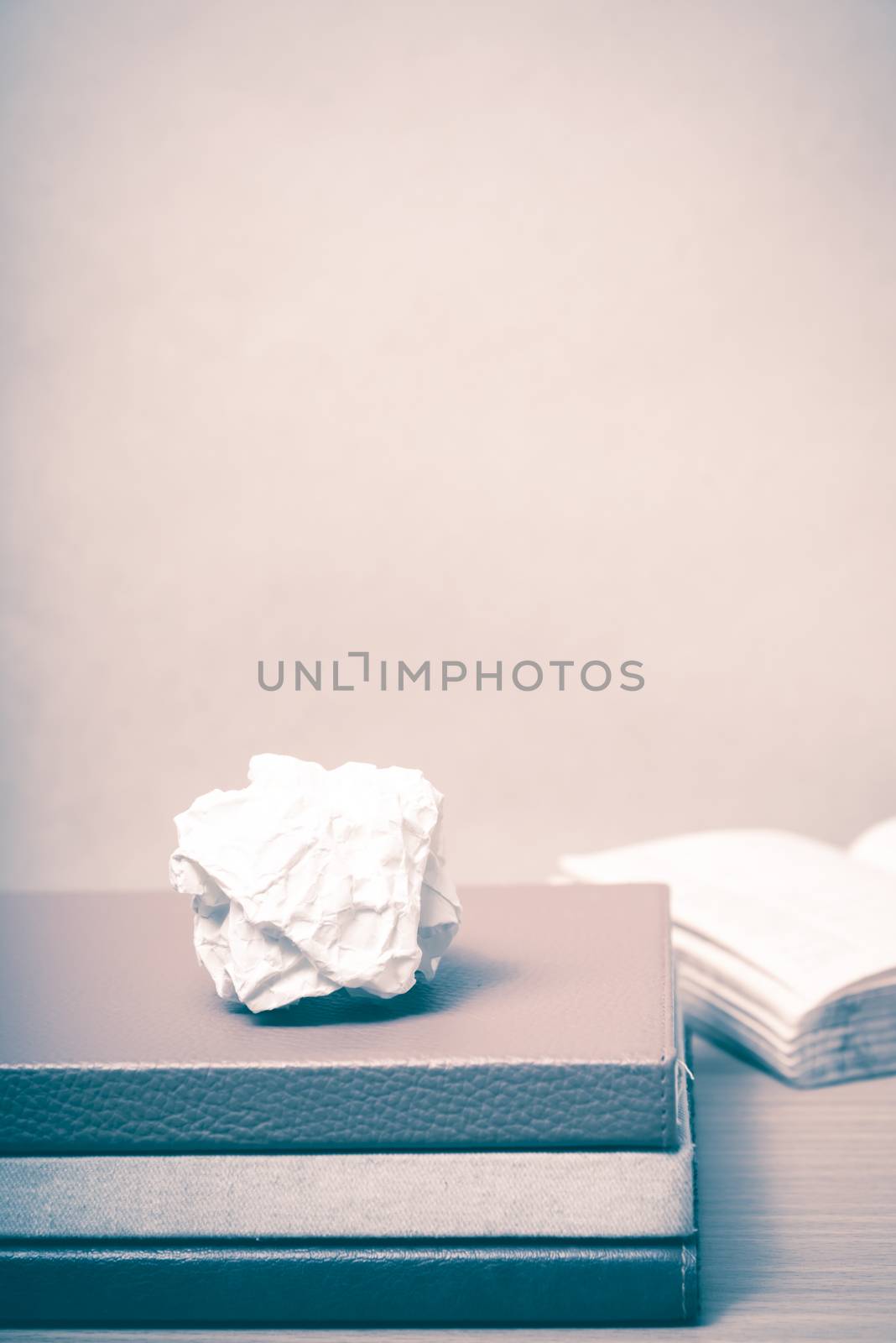 book and crumpled paper on wood background vintage style