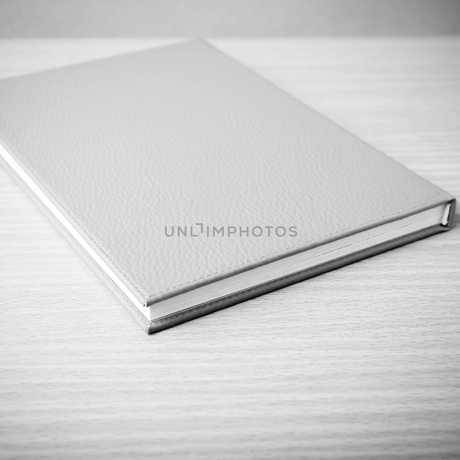 book on wood table background black and white color tone style