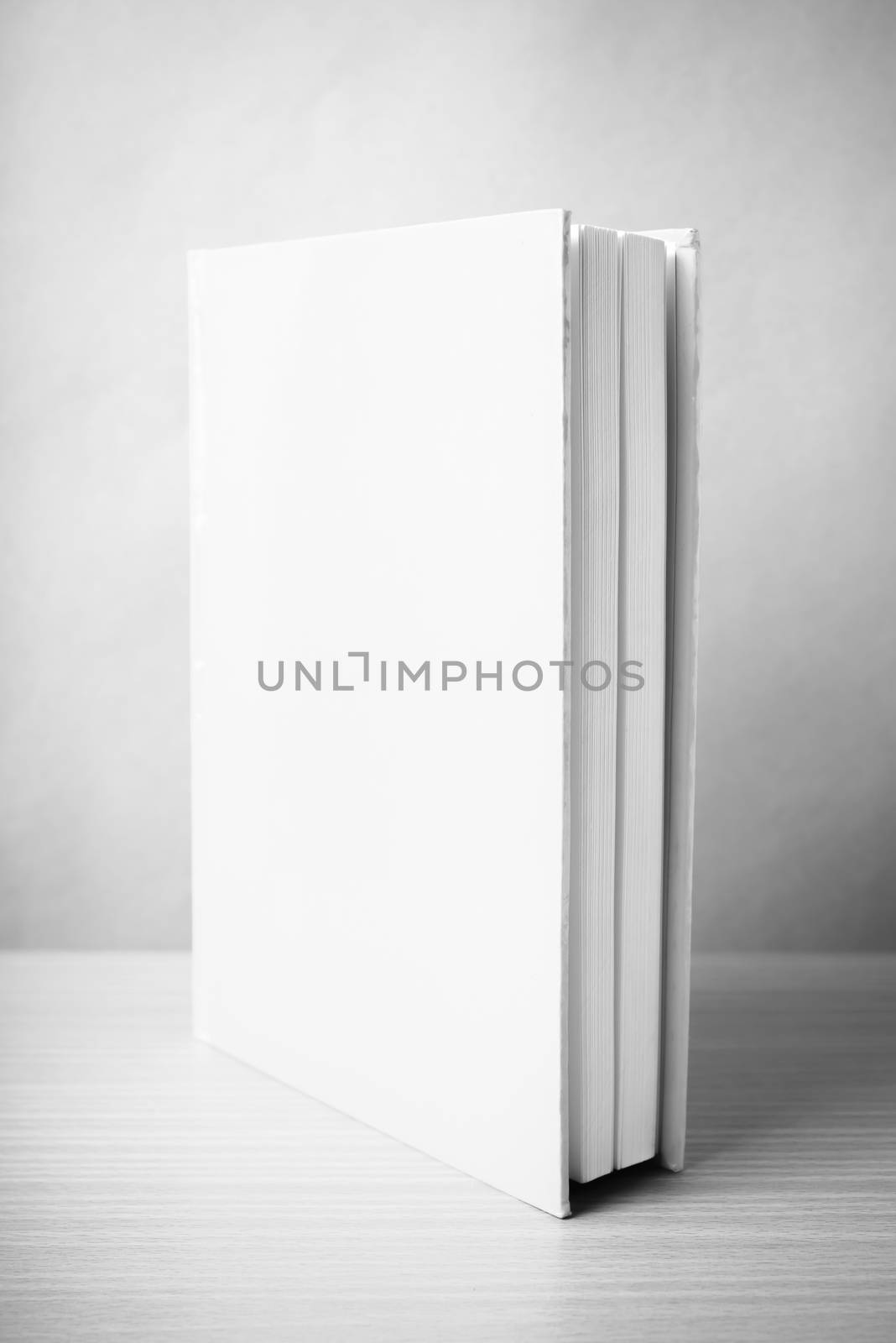 book on wood table background black and white color tone style