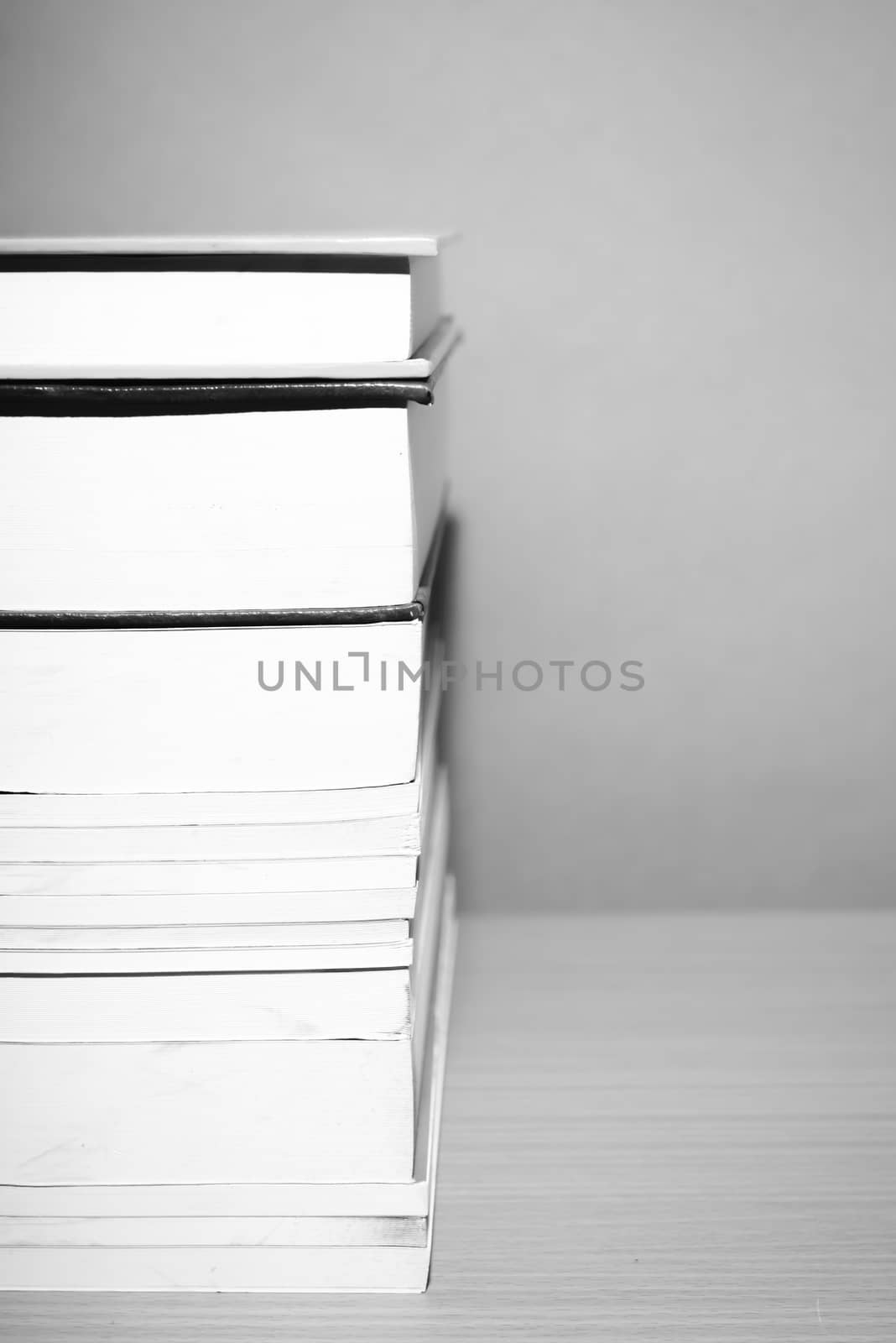 stack of book on wood table background black and white color tone style