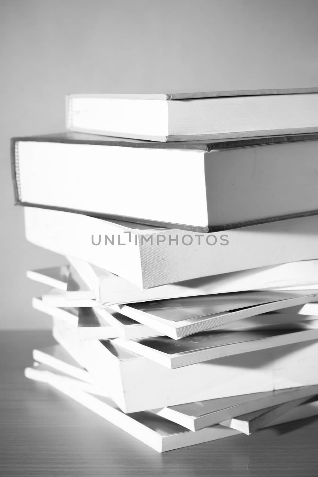 stack of book on wood table background black and white color tone style