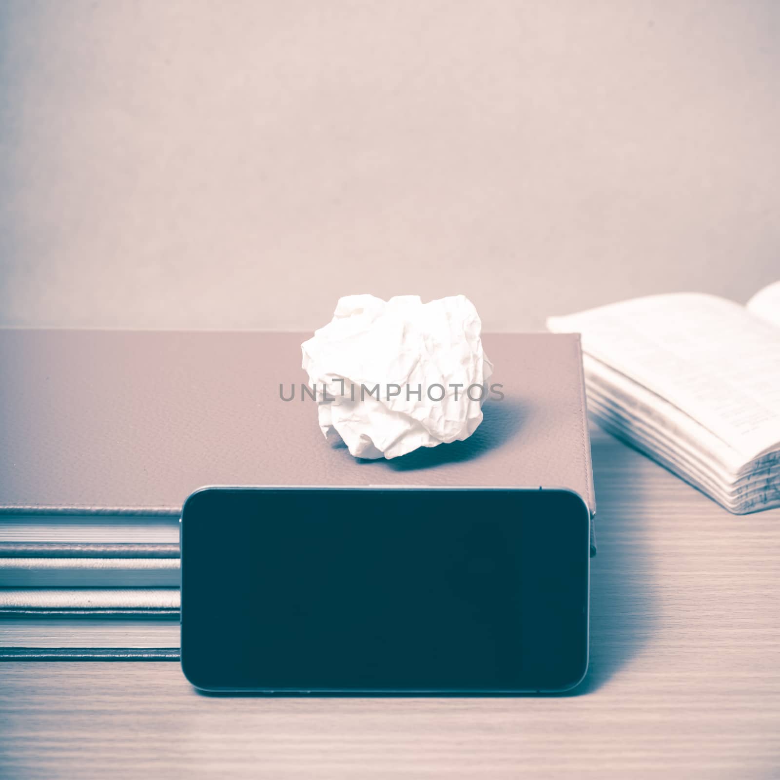 stack of book with smart phone on wood background vintage style