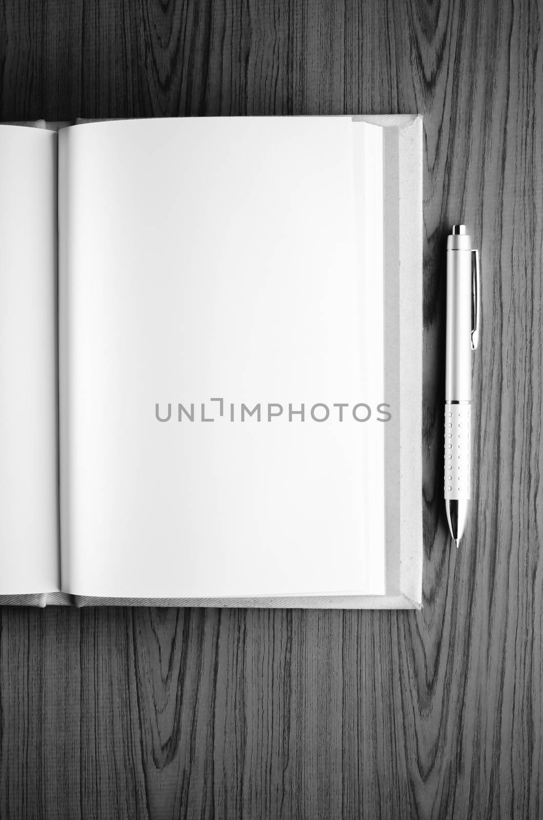 notebook on wood background black and white color tone style