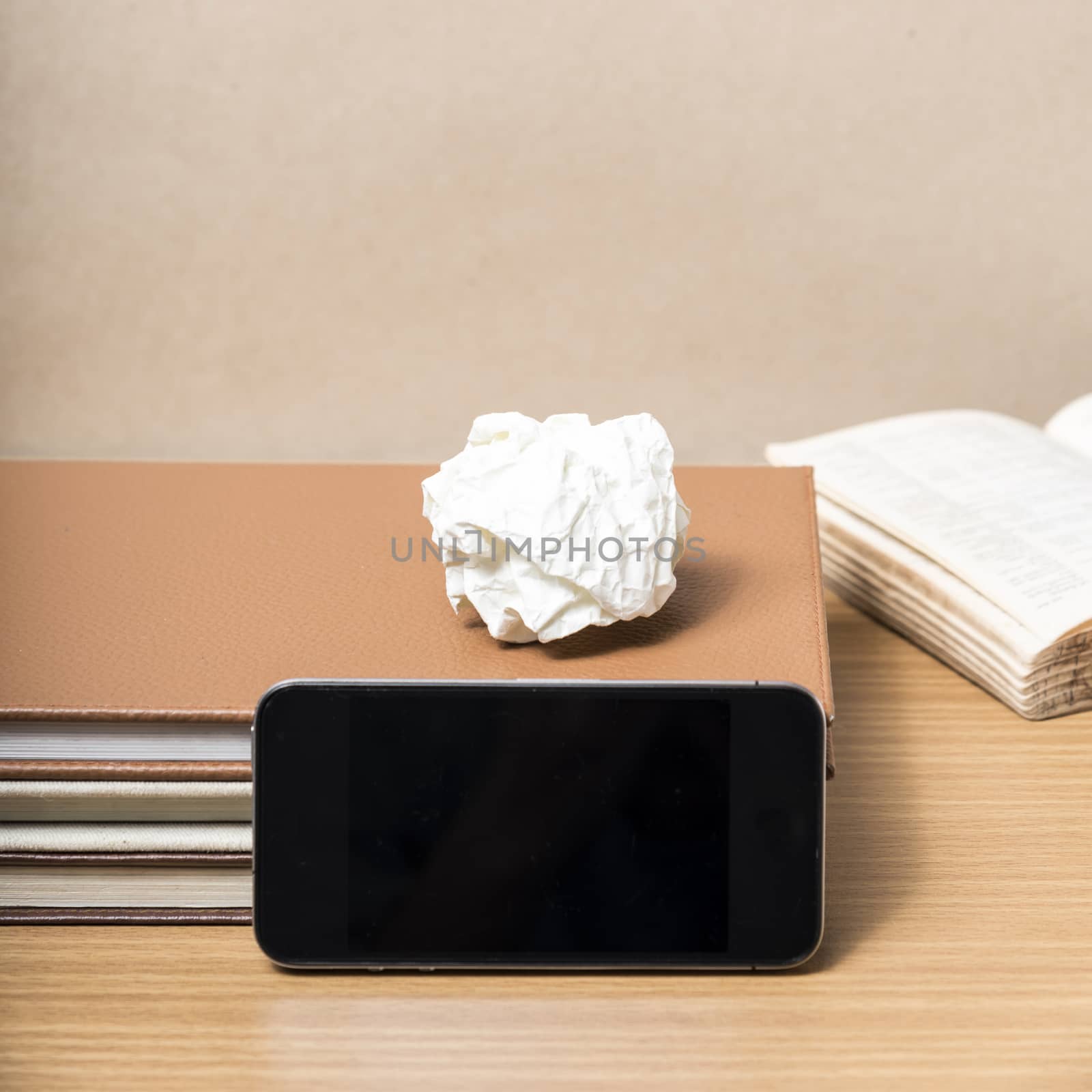 stack of book with smart phone on wood background