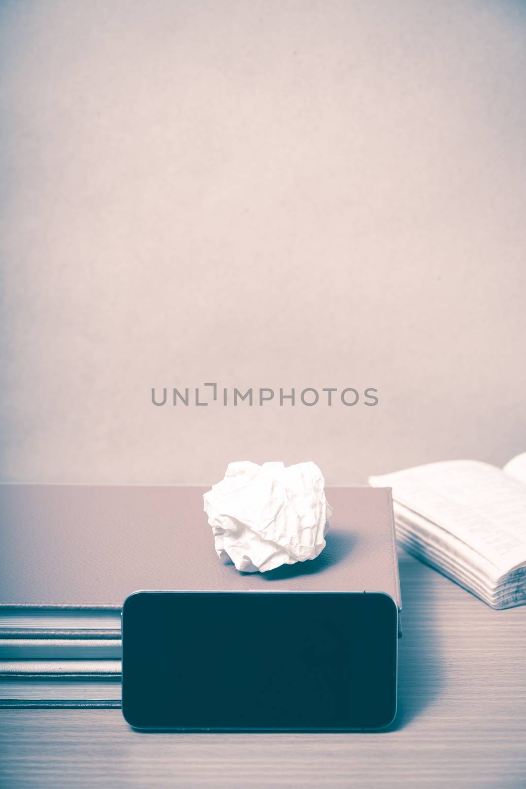 stack of book with smart phone on wood background vintage style