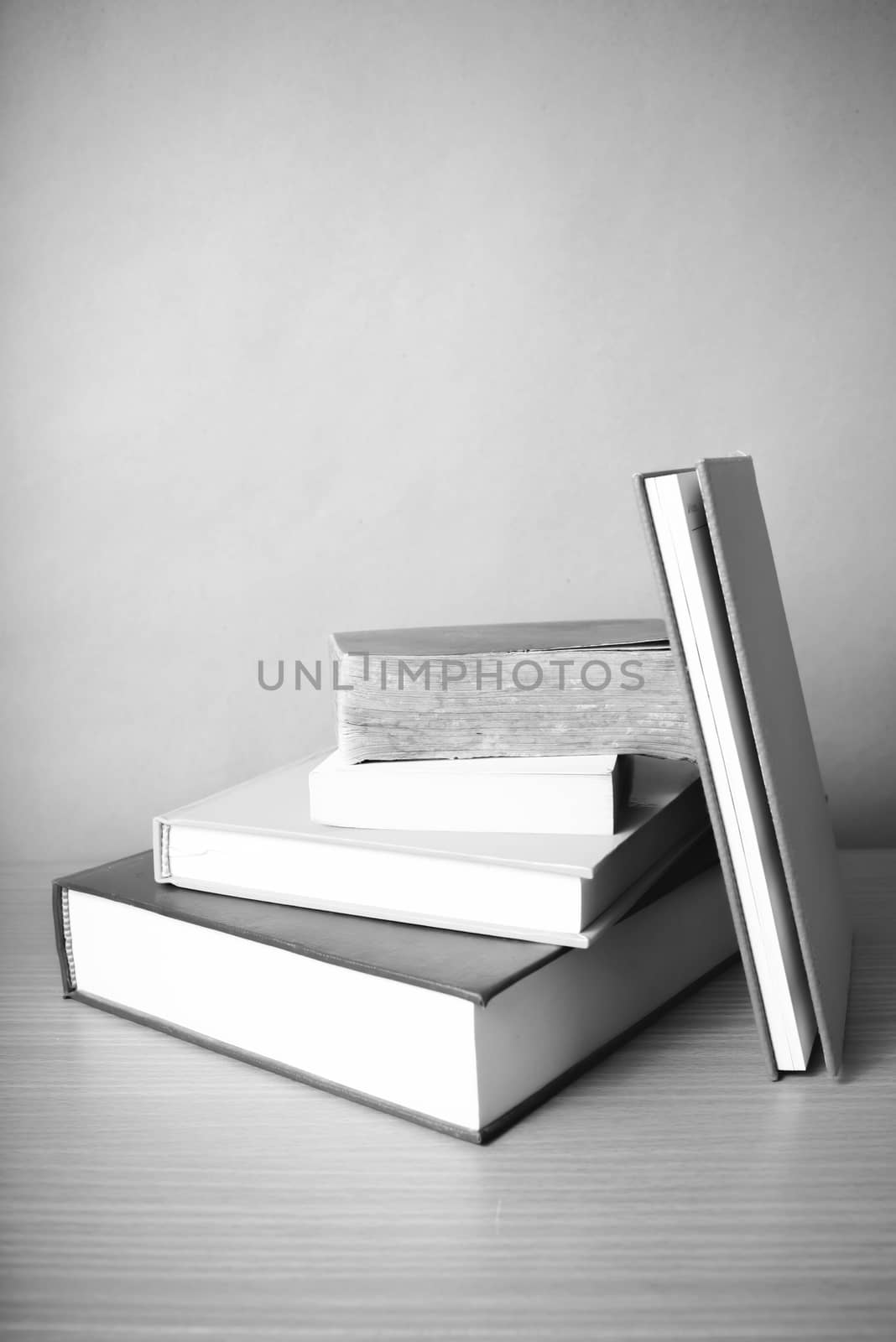 stack of book on wood table background black and white color tone style