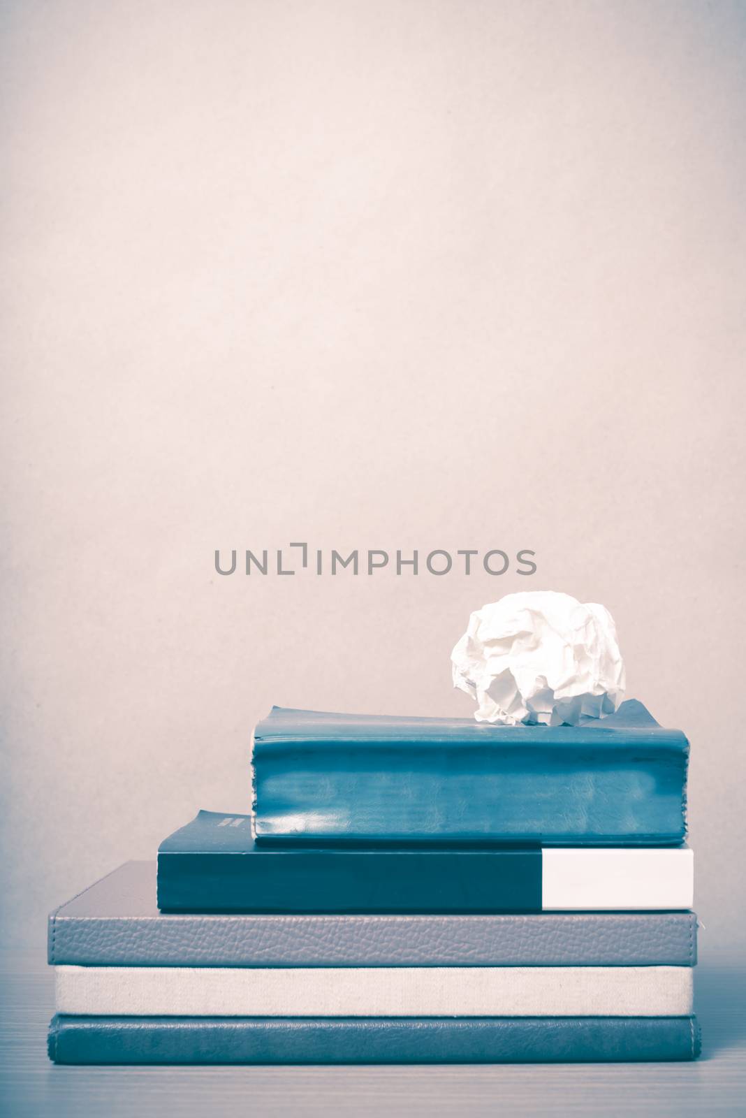 book and crumpled paper on wood background vintage style