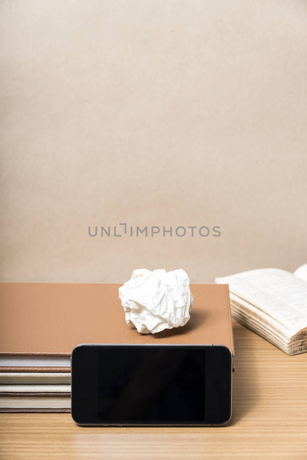 stack of book with smart phone on wood background