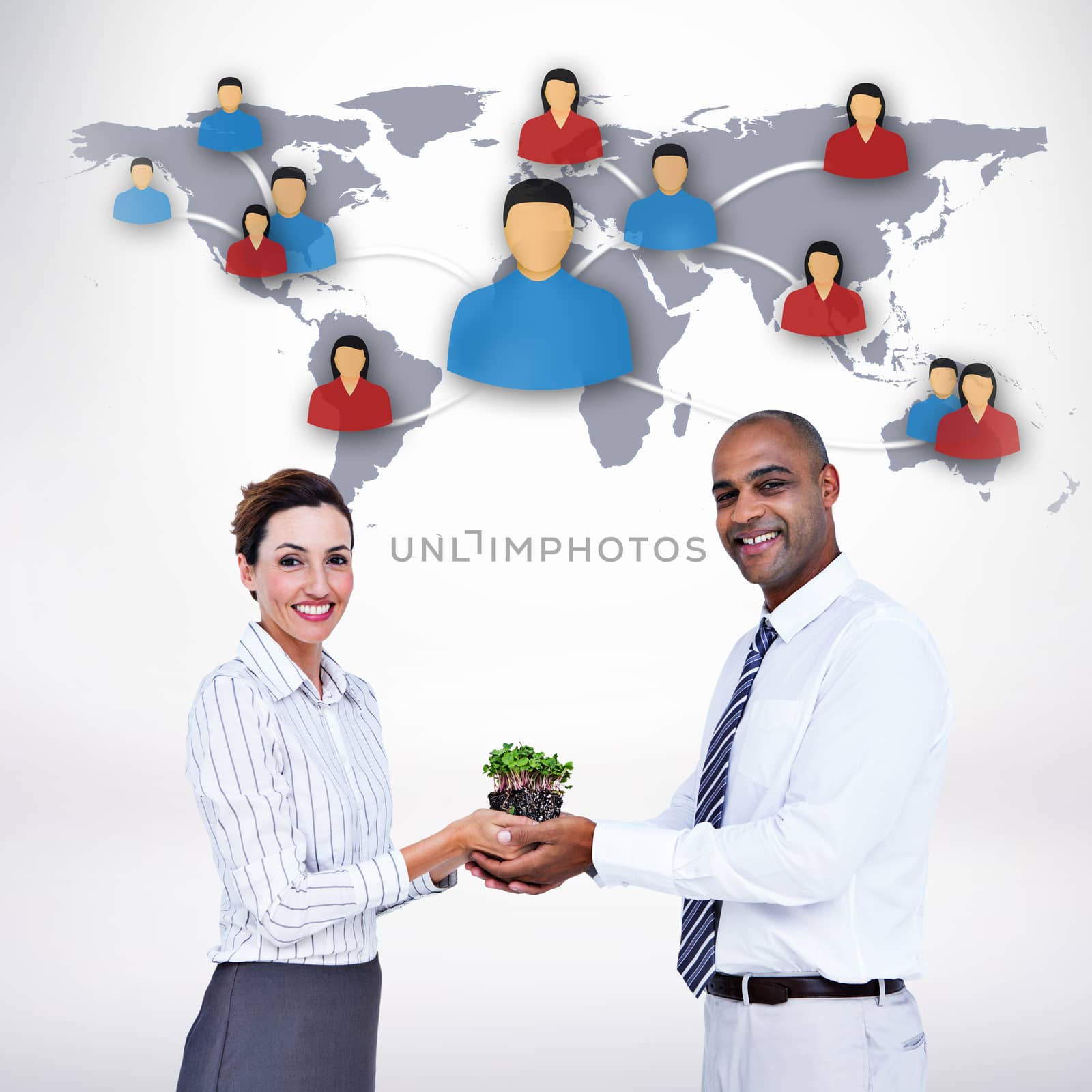 Composite image of business colleagues holding plant and looking at camera by Wavebreakmedia