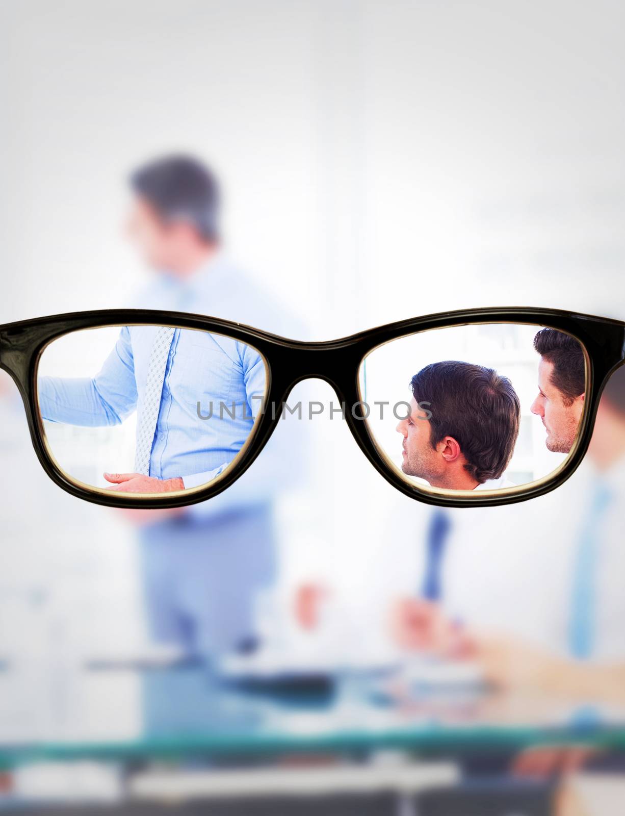 Glasses against business people in office at presentation