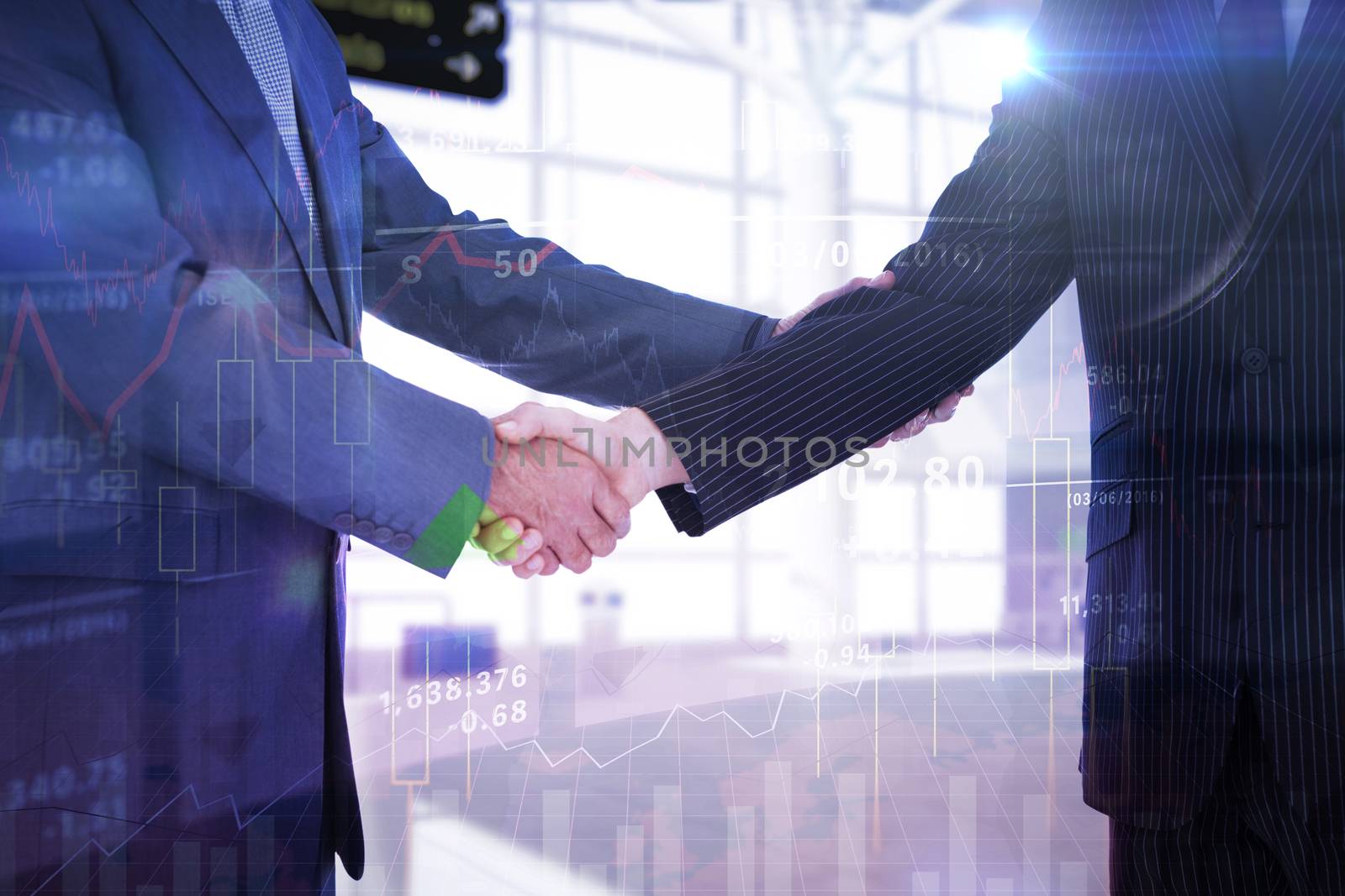 Handshake in agreement against stocks and shares