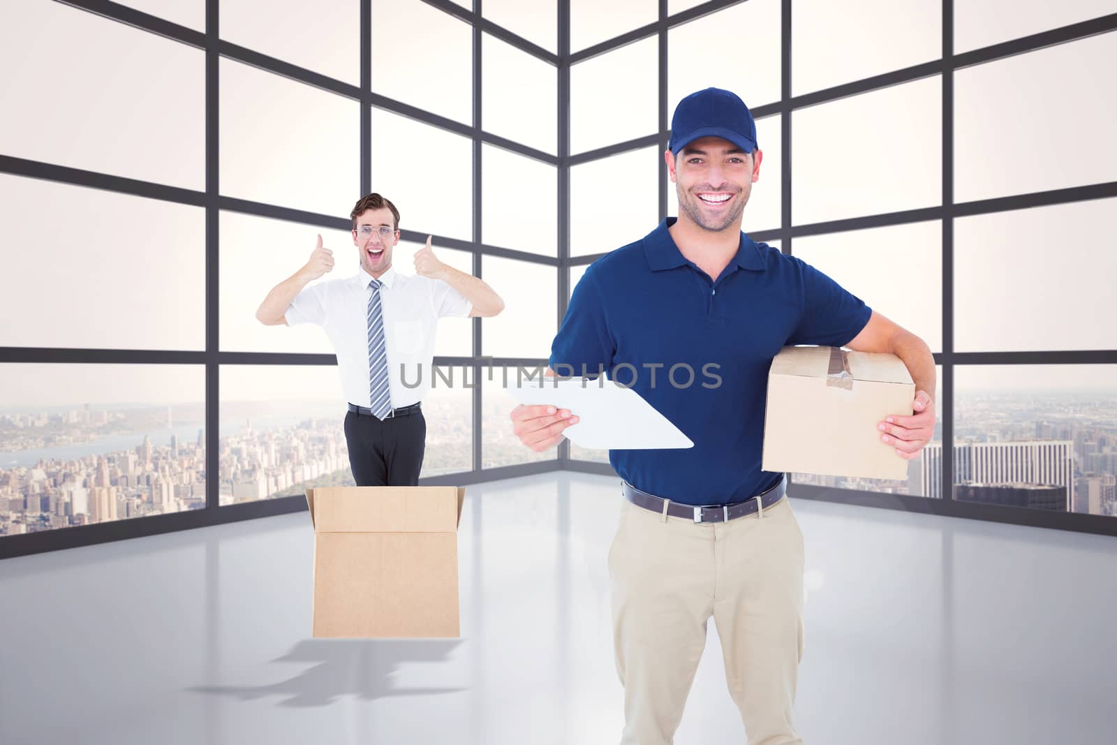 Happy delivery man with cardboard box and clipboard against room with large window showing city