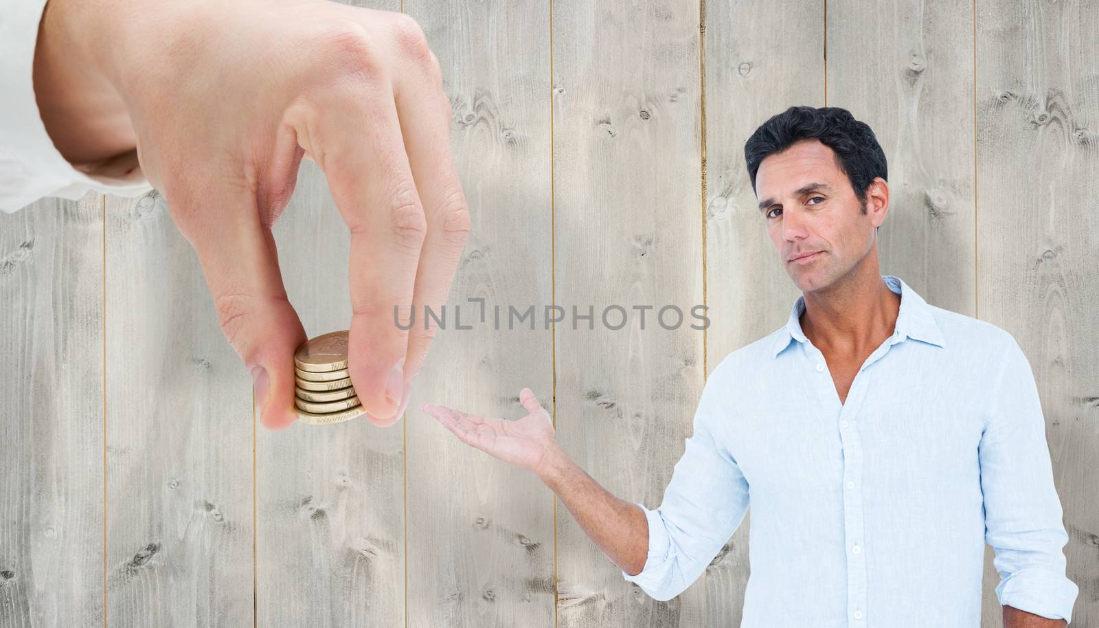 Handsome man looking at camera against pale wooden planks