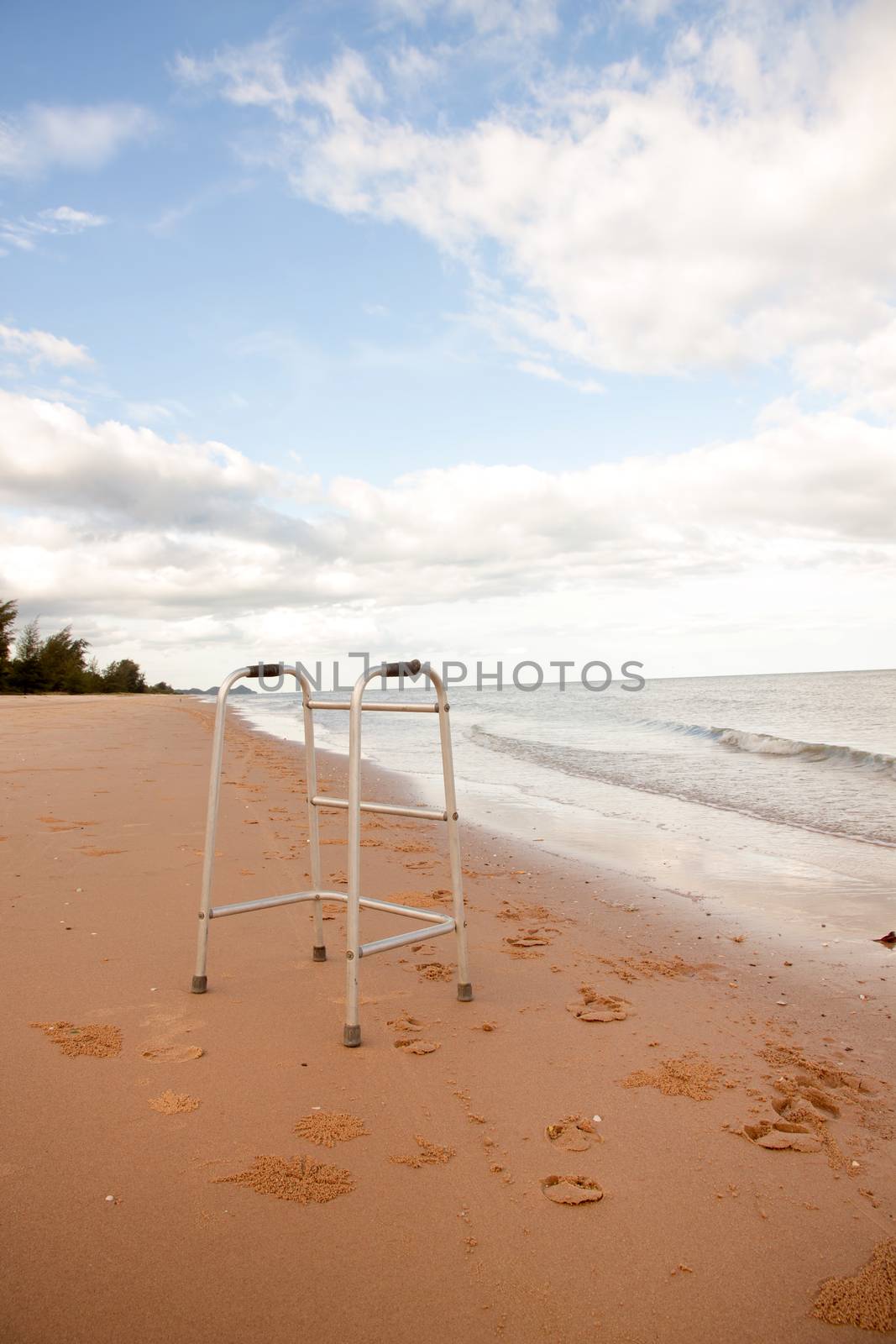 walker on sand beach. convey in meaning the relax tourist attractions of the elderly.