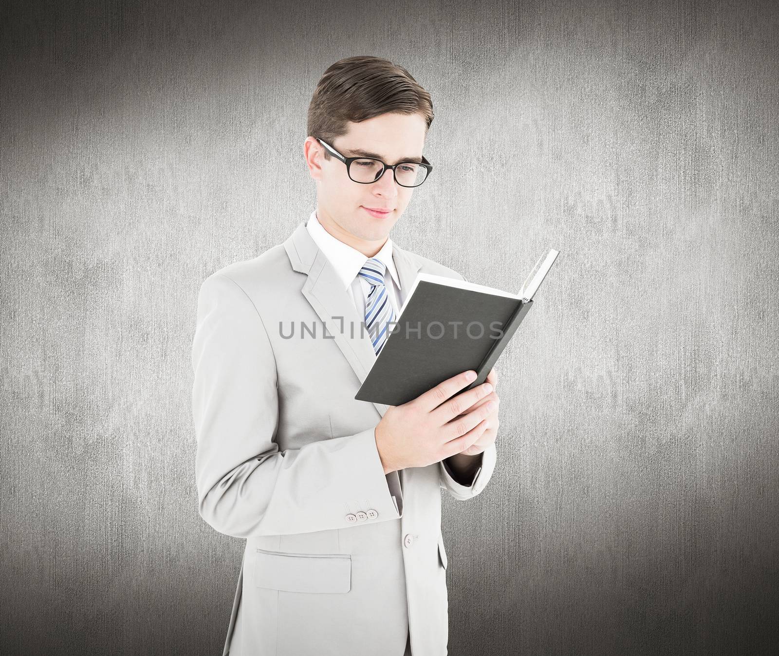 Composite image of geeky businessman reading black book by Wavebreakmedia