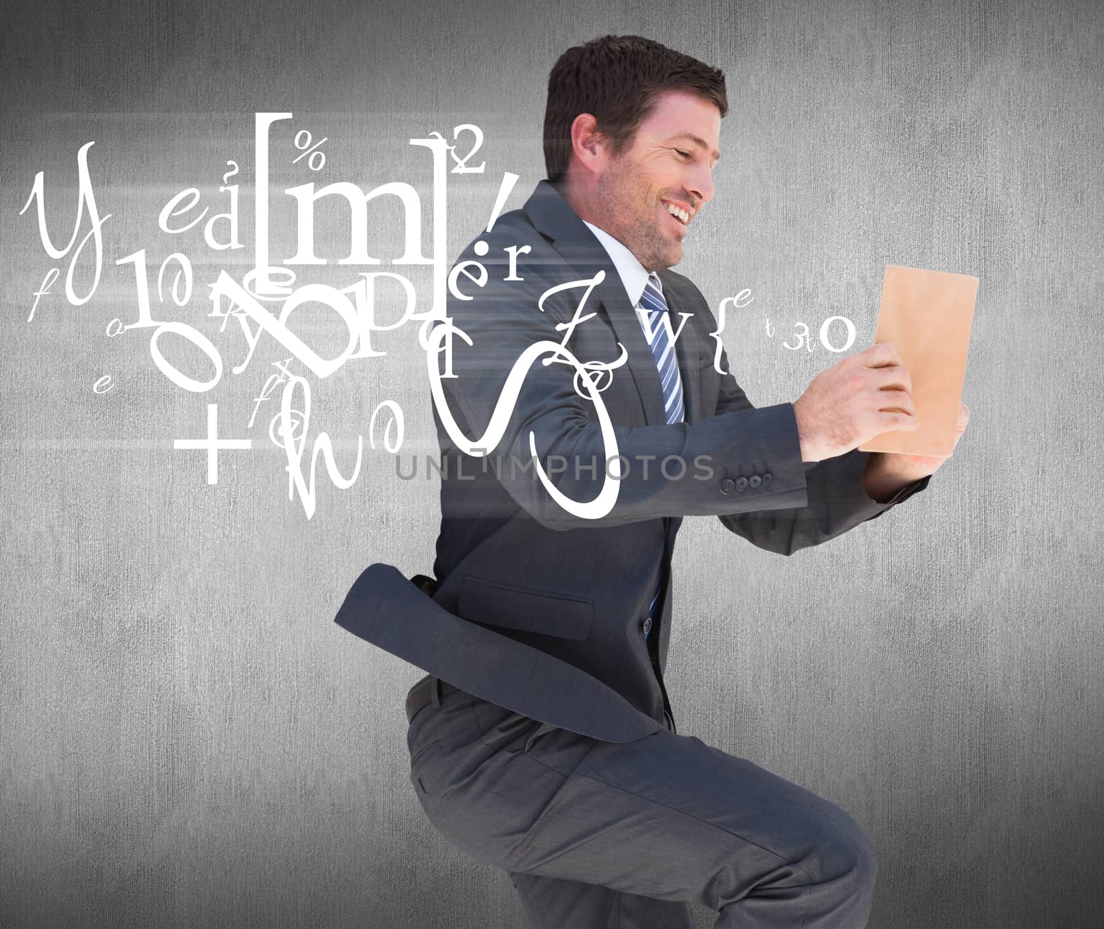 Businessman lying on the floor reading a book against white and grey background