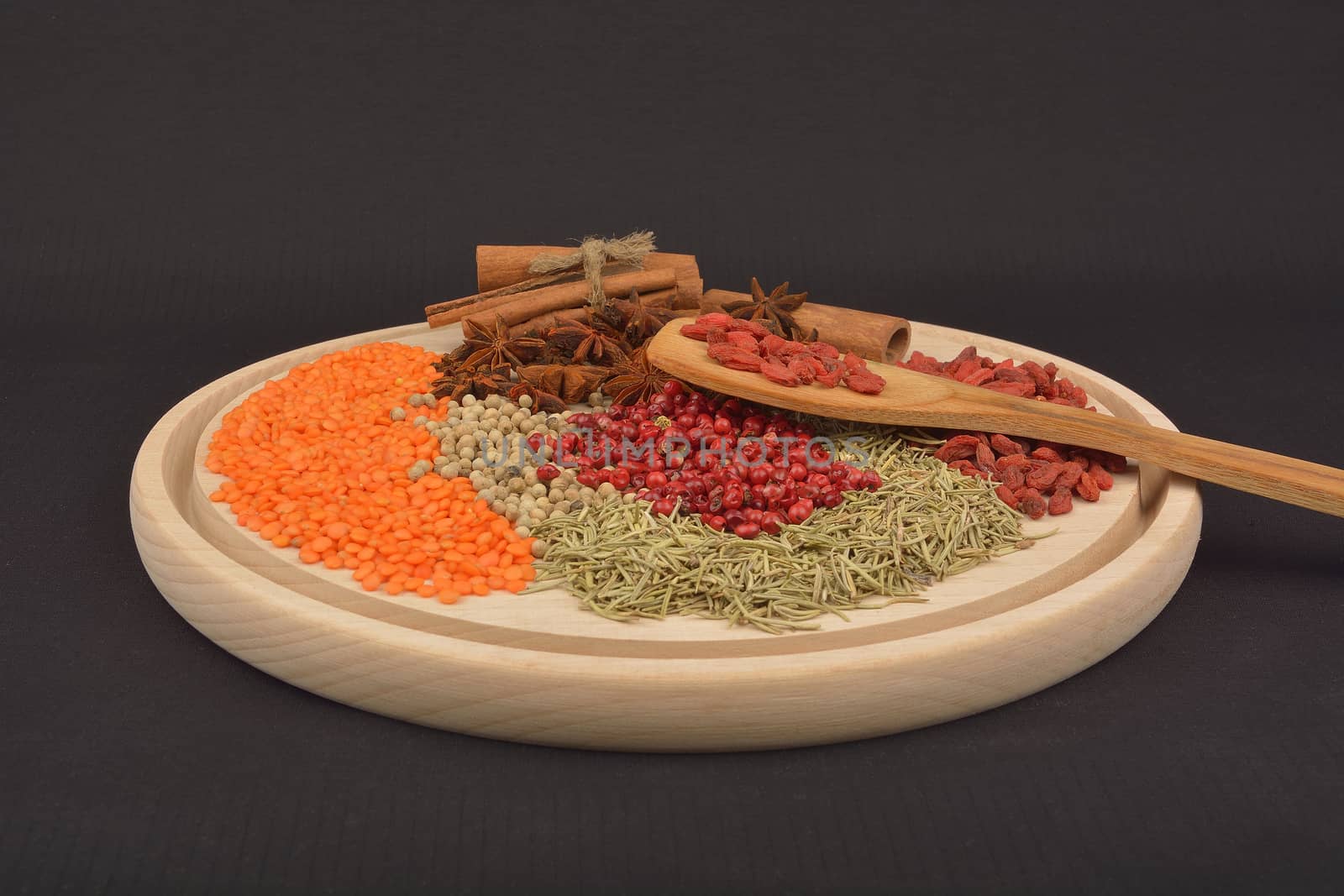 different spices on wooden background by constantinhurghea