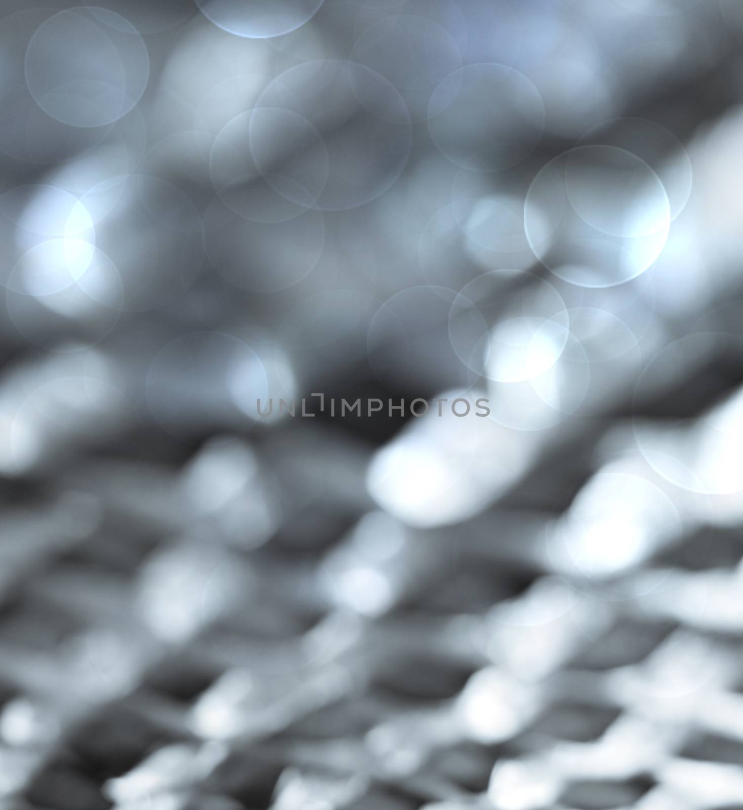 Silver colored  bokeh lights abstract background.