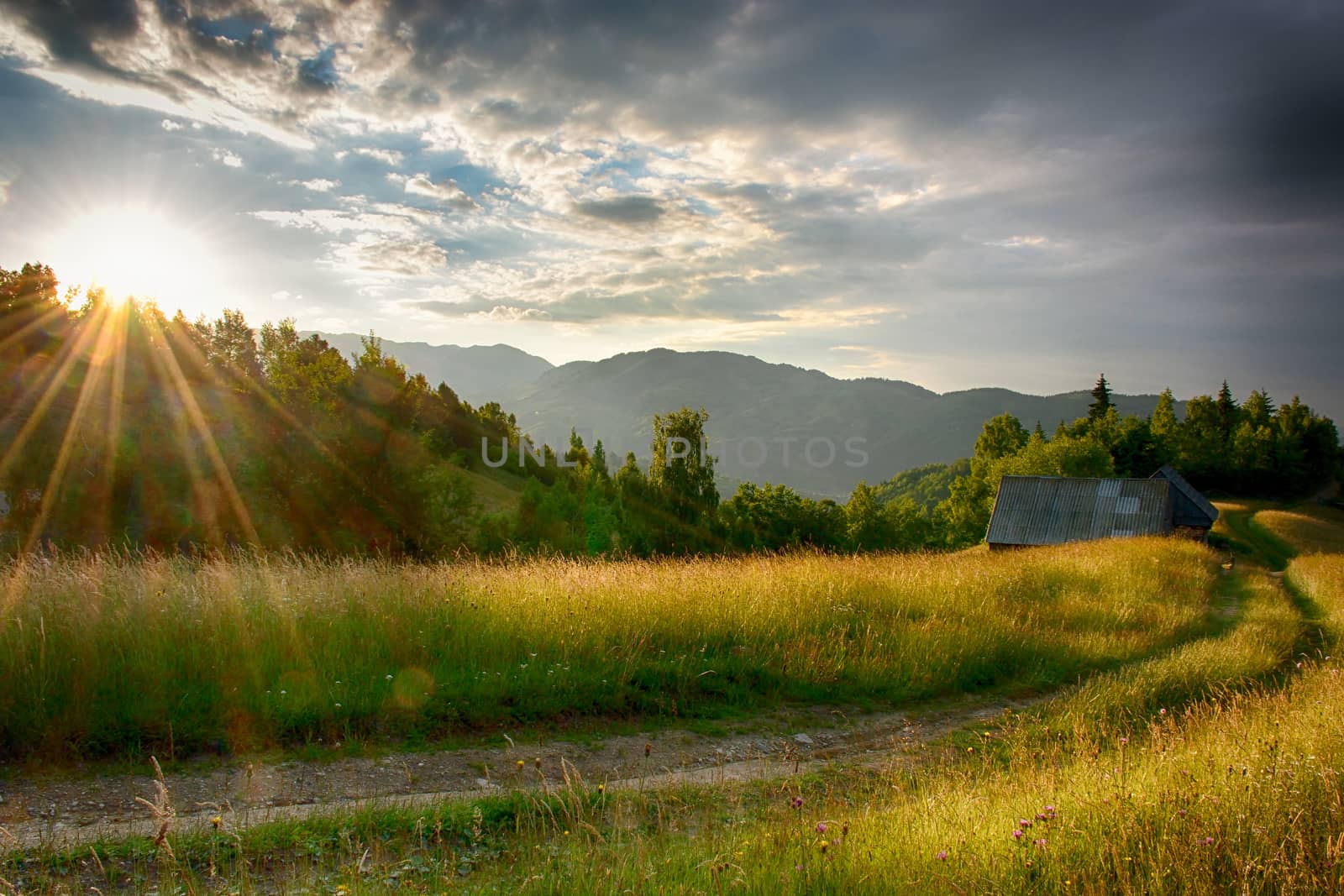 Evening, sunset on mountain hills of Simon village. Bran. by constantinhurghea