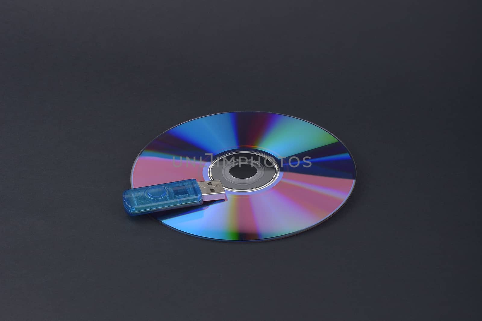 Flash card lying on a disk on a dark grey background by constantinhurghea