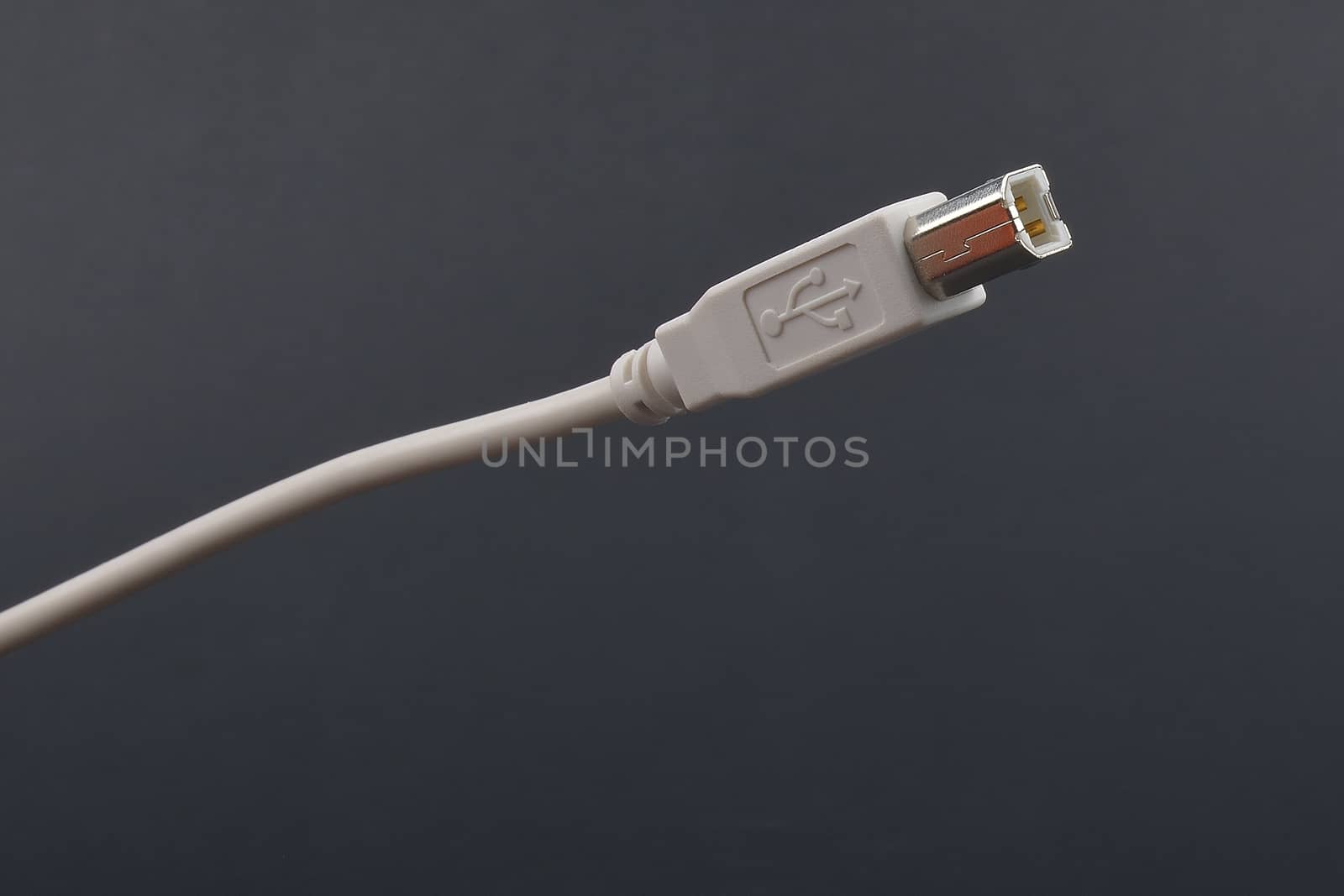 USB Cable Plug  on dark background by constantinhurghea