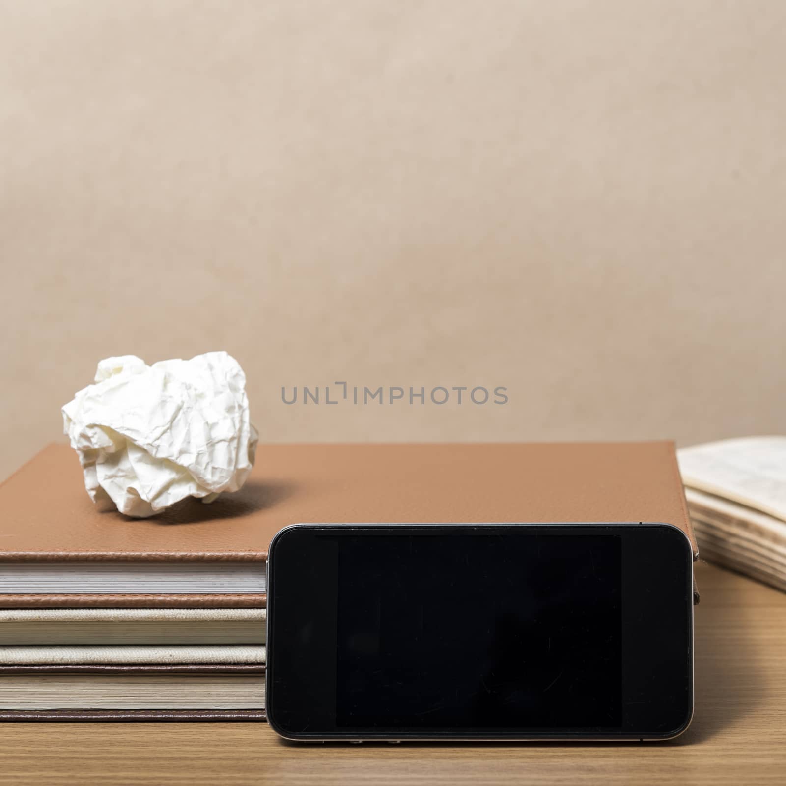 stack of book with smart phone on wood background