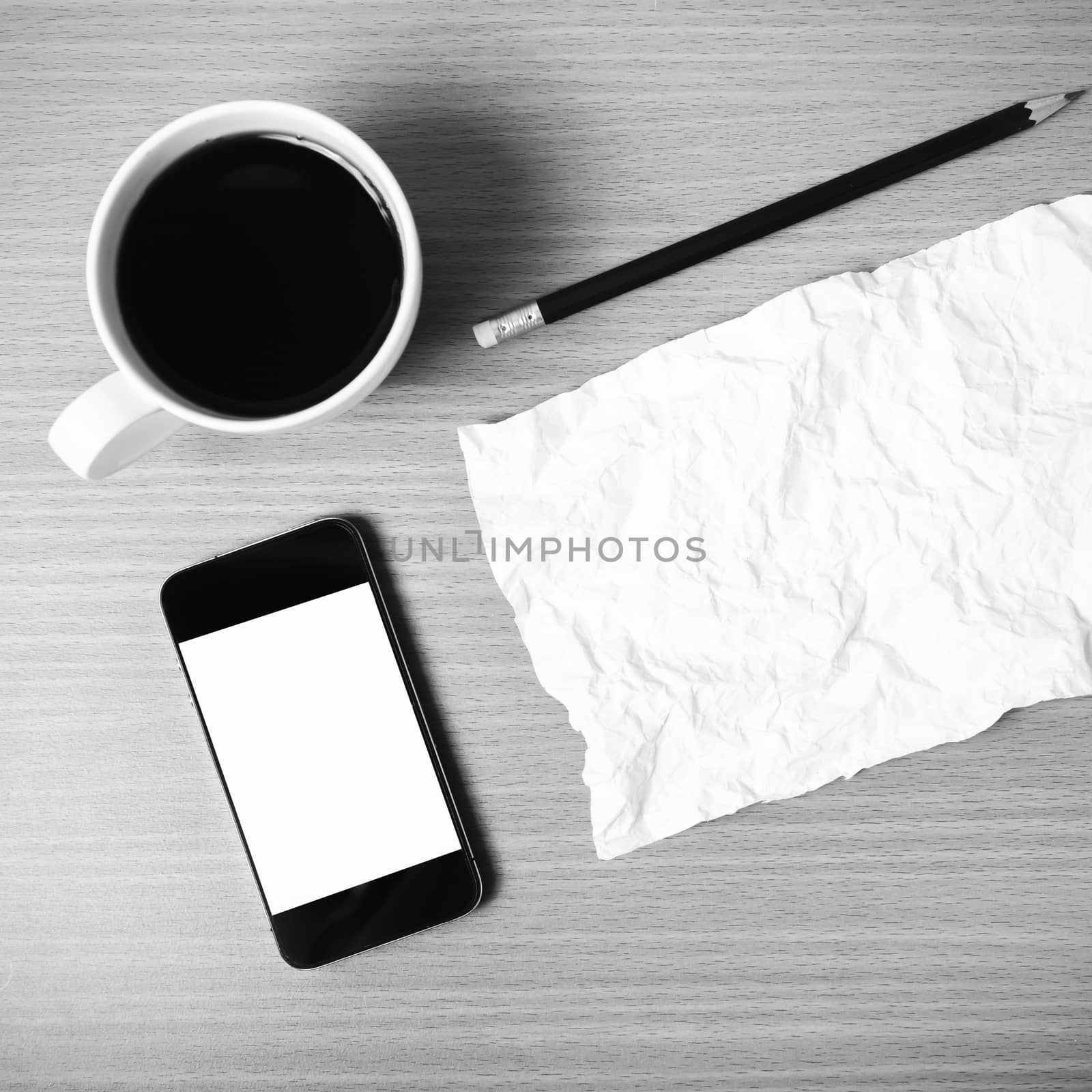 paper smart phone coffee cup and pencil on wood background black and white color tone style