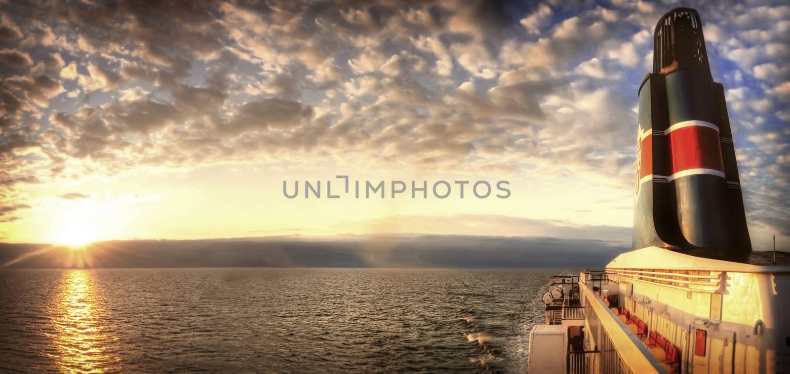 Travel conceptual image. Sunset over the sea visible from the ferry.
