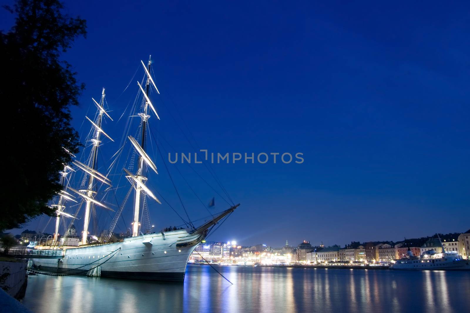 Famous city conceptual image. Ship in the port of stockholm at night.