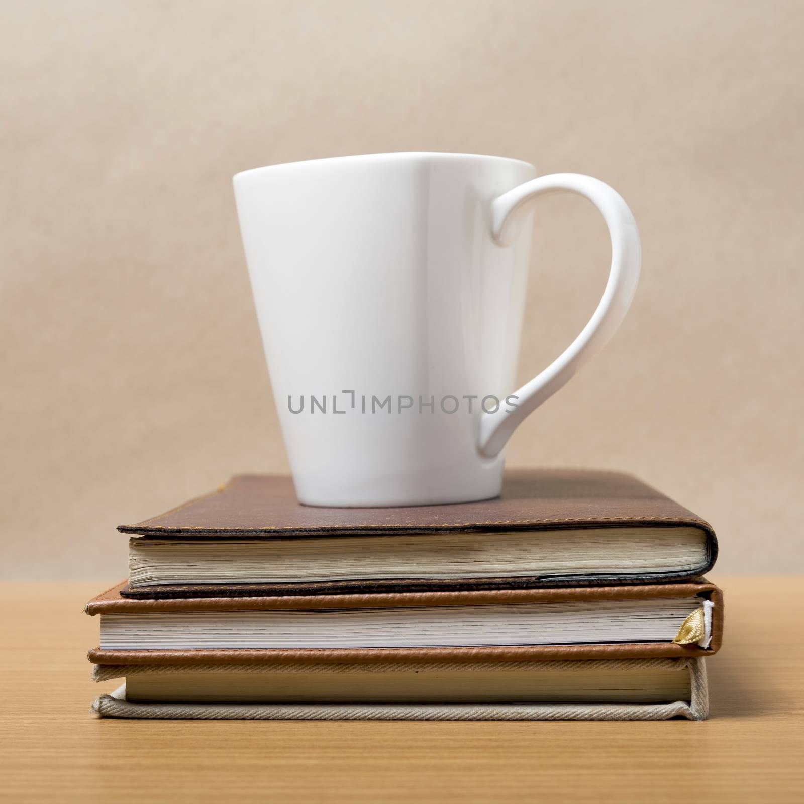 stack of book with coffee mug on wood background