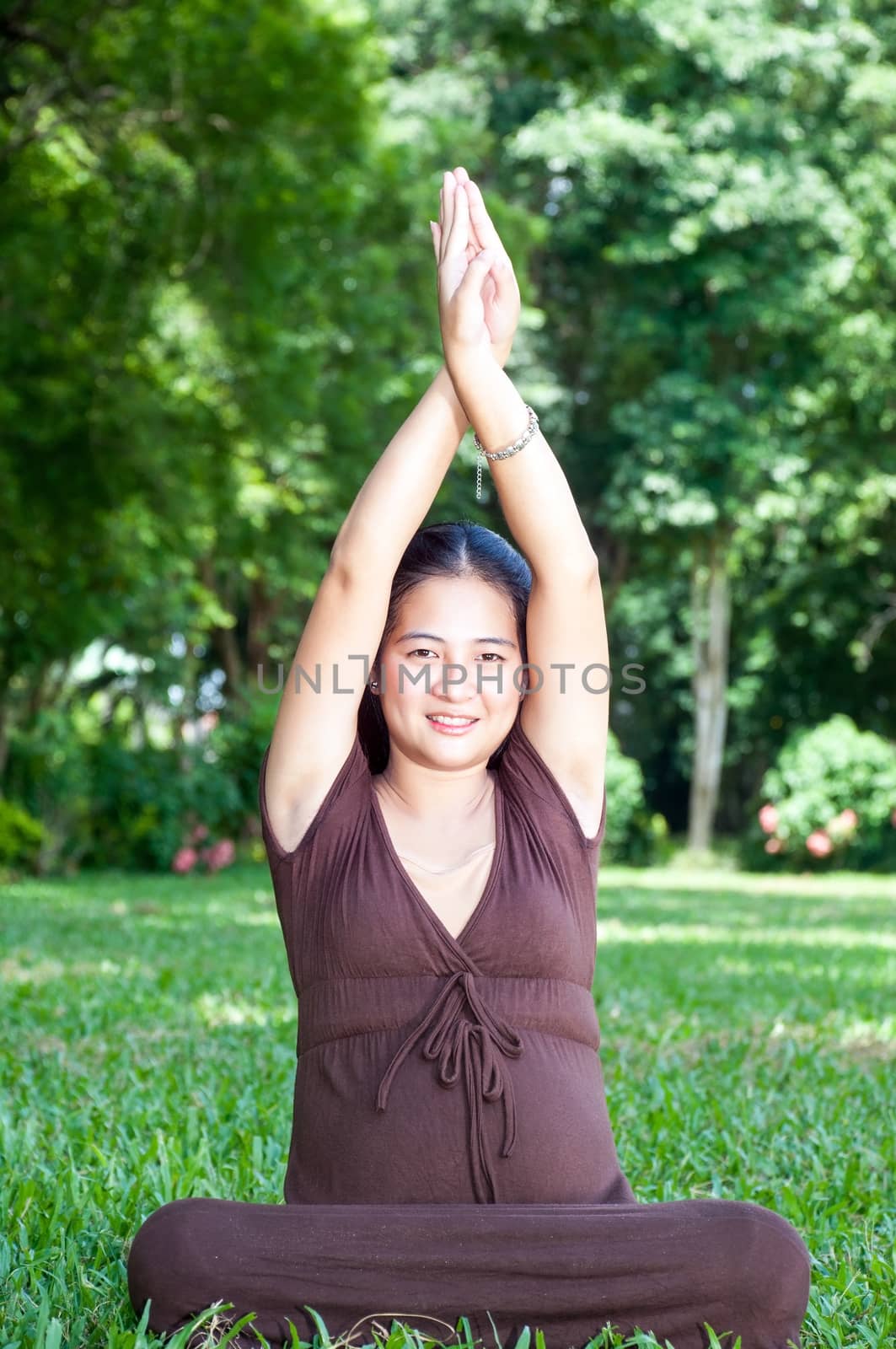 Pregnant woman sitting in the park . in anticipation of the child. Senses of tenderness, love and motherhood. toned photo