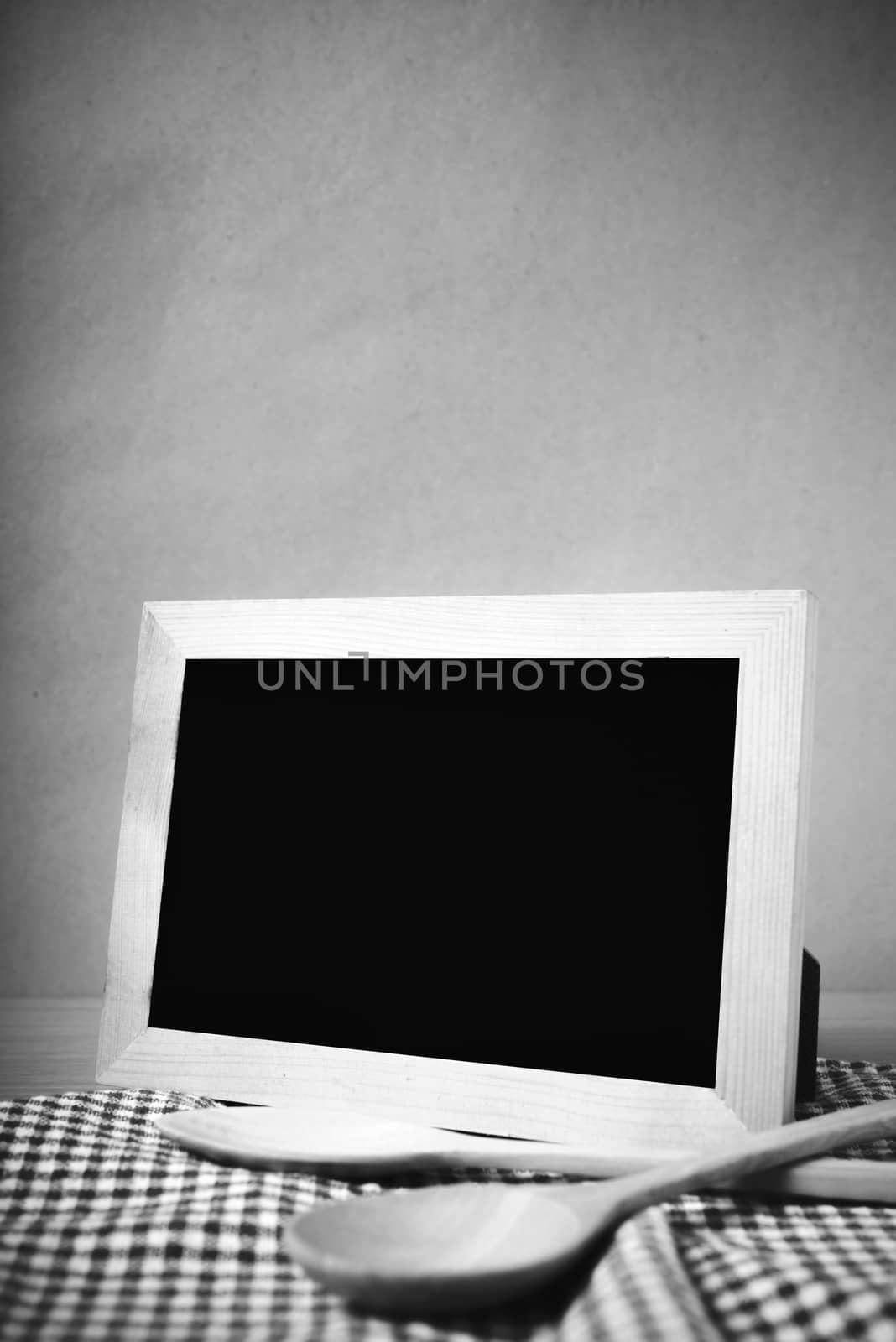 blackboard and wooden spoon on table black and white color tone style