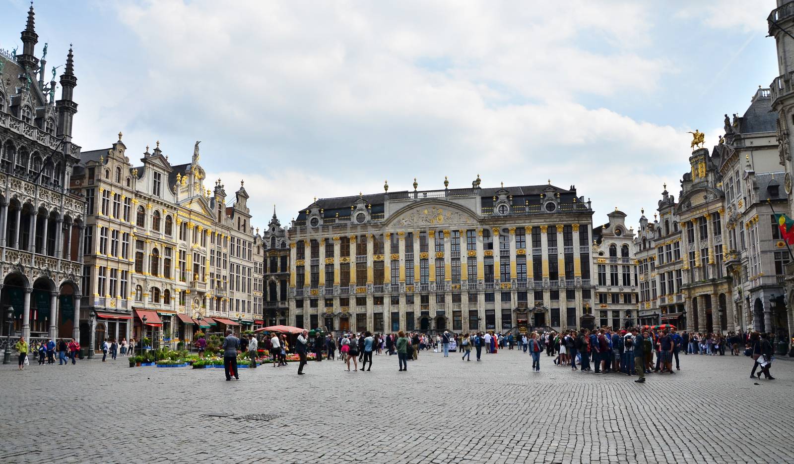 Brussels, Belgium - May 12, 2015: Tourists visiting famous Grand Place of Brussels.