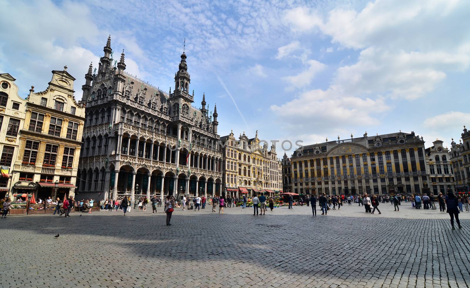 Brussels, Belgium - May 12, 2015: Tourists visiting famous Grand Place the central square of Brussels.
