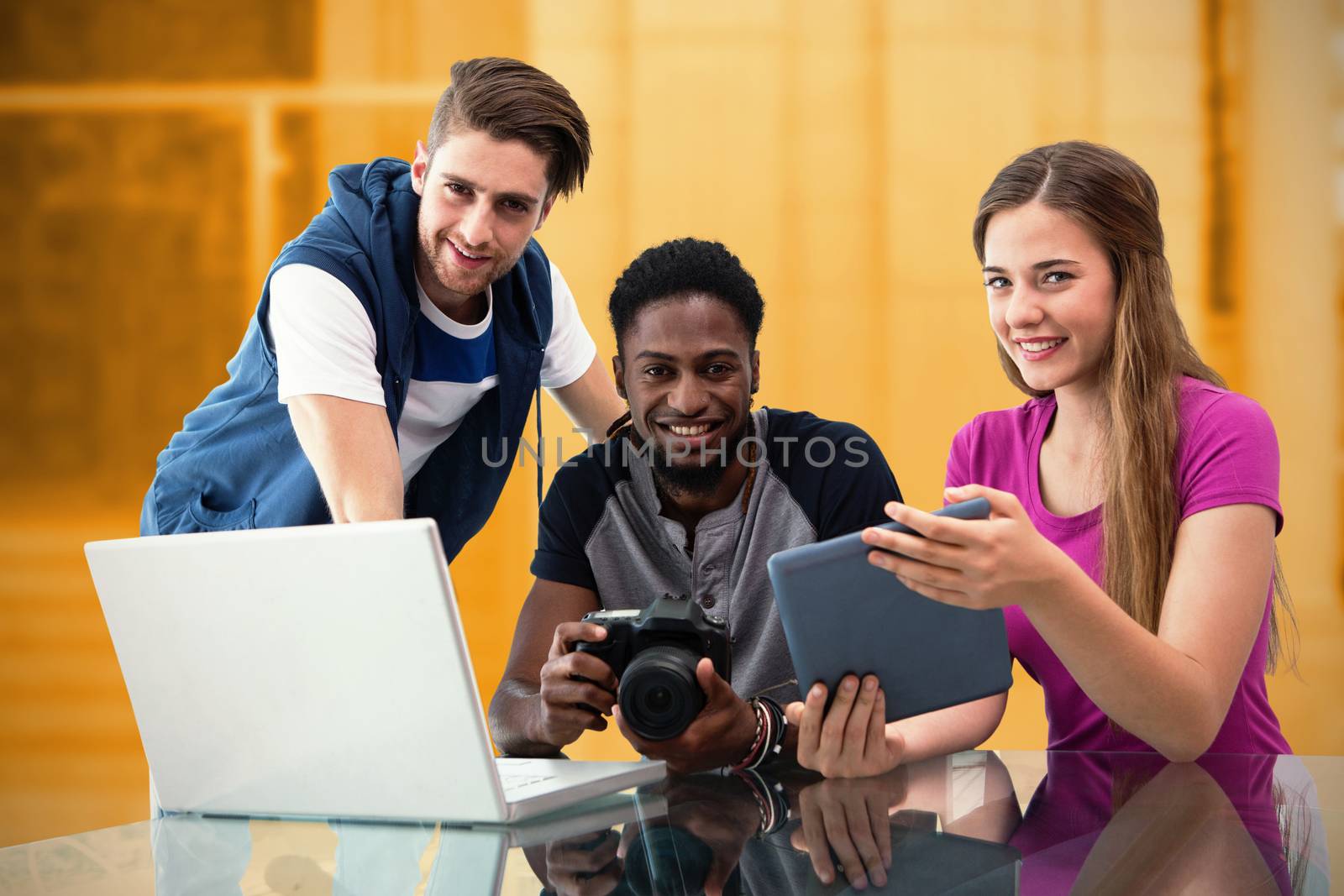 Composite image of creative young business team looking at digital tablet